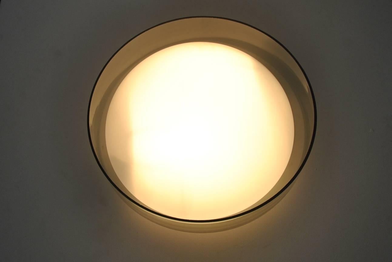 Opaline white glass in the middle with grey/smoked glass on the outside. It has a very soft form that combines very good with the hard glass material. Really a beautiful lamp that gives a very nice light to your room. 
This light was sold by high