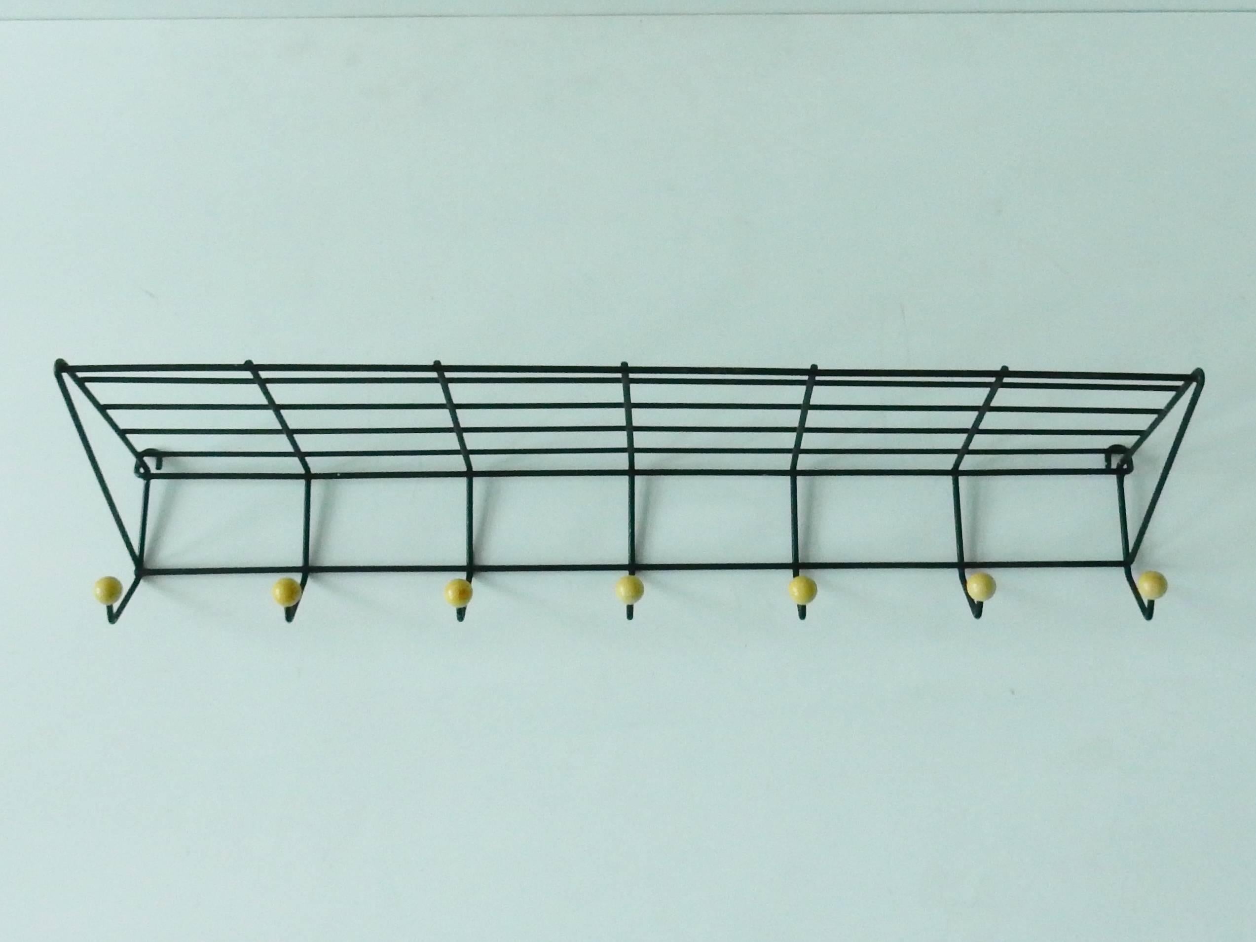 A design by Friso Kramer from 1956 for the company, 't Spectrum. This coat rack is made from black lacquered rod steel. An Industrial Design that is a great example of Dutch design from this era.
This version with seven hooks is the largest version