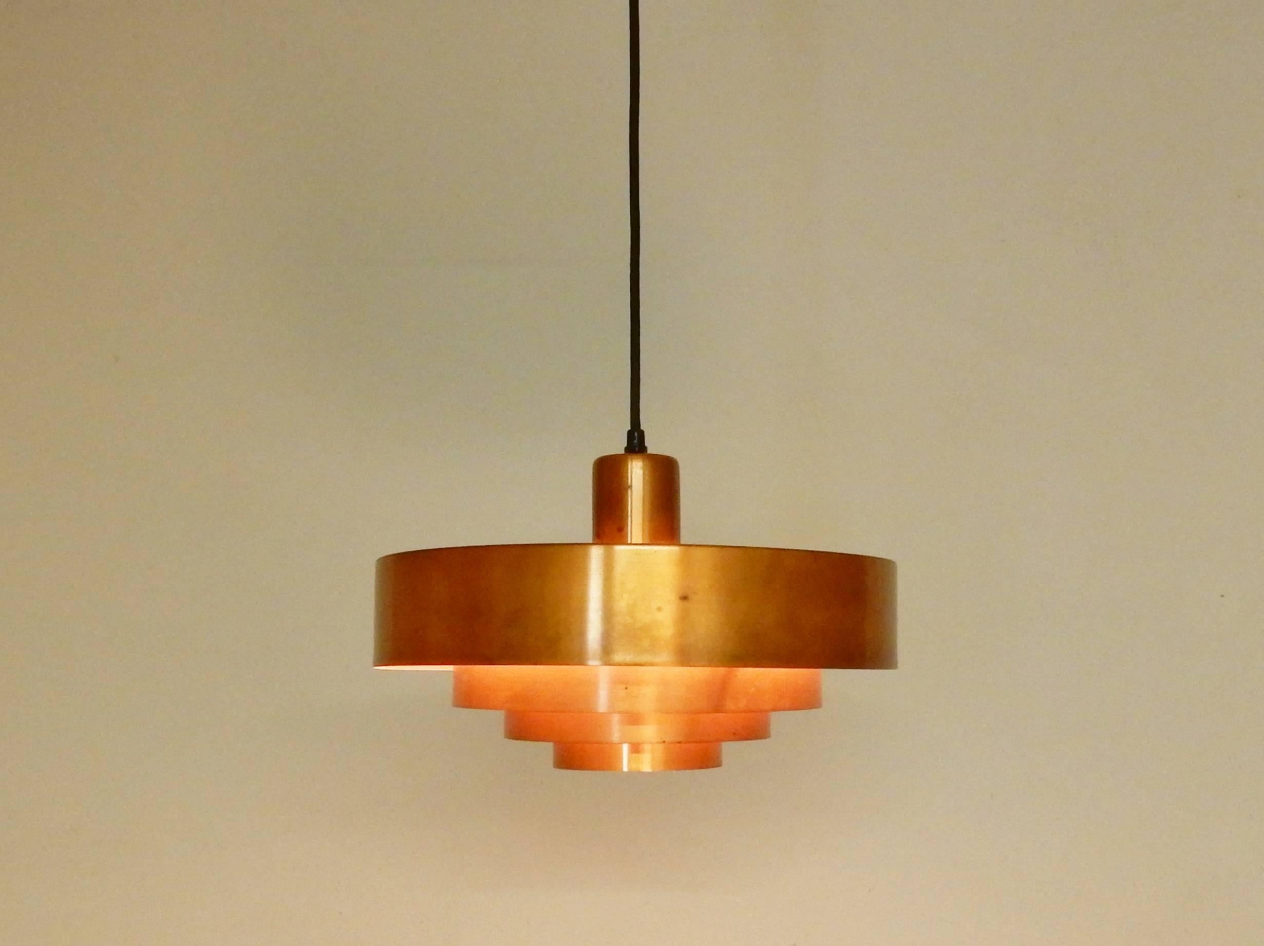 This brass pendant light is a design by Jo(hannes) Hammerborg for Fog & Mørup from Denmark. A design for the 1960s but still very applicable in many interiors today. The simple and elegant design combined with the brass metal makes a great