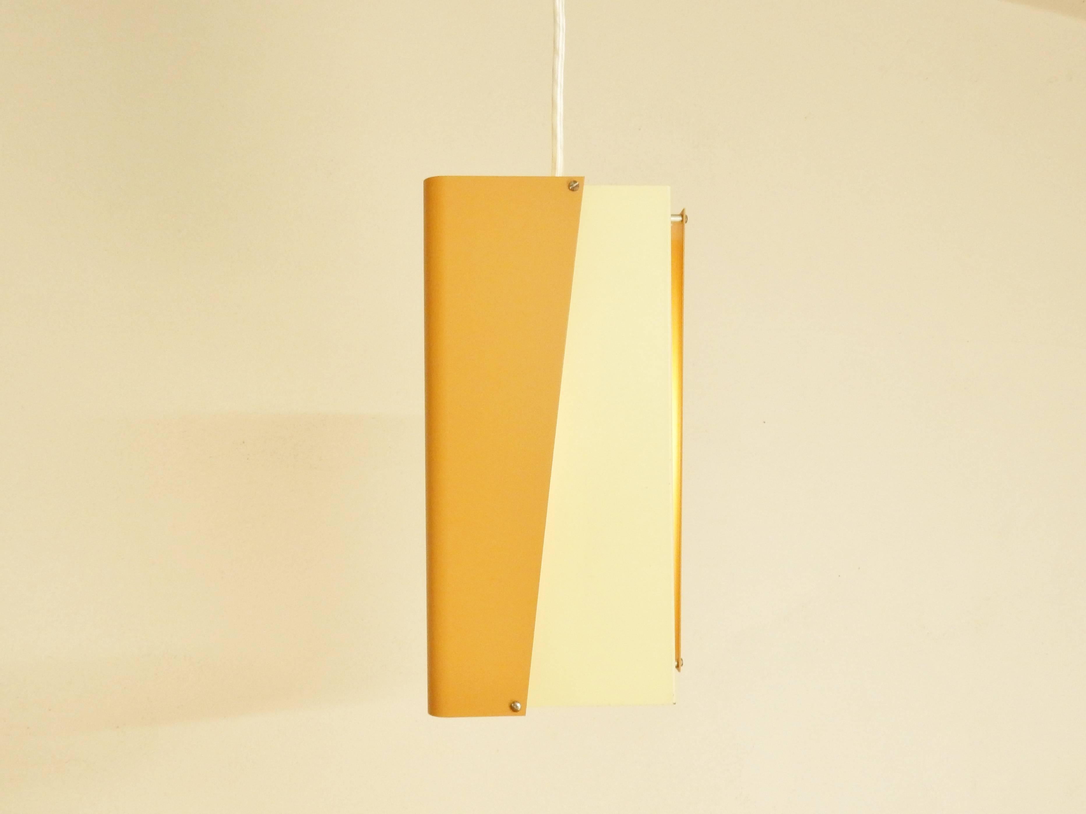 Orange and cream or off-white colored pendant lamp by Danish lighting manufacturer Lyfa. This light is a rare design that is not offered much. An arrangement of 4 in color lacquered folded metal sheets. The light is labelled with a sticker on the