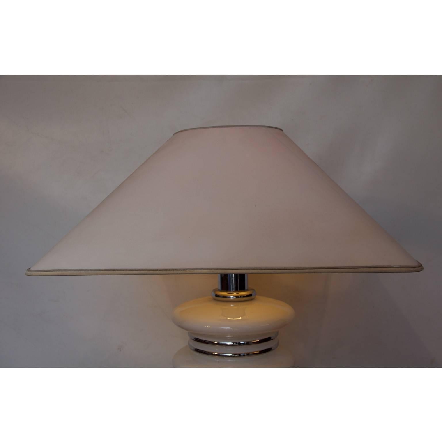 White glass and chrome table lamp from the Mid-century.

All our lights are checked and tested. Because of the lower voltage standard in the USA (110v vs 220v), European lighting can be safely used in the USA. If a lamp has a plug, only the plug