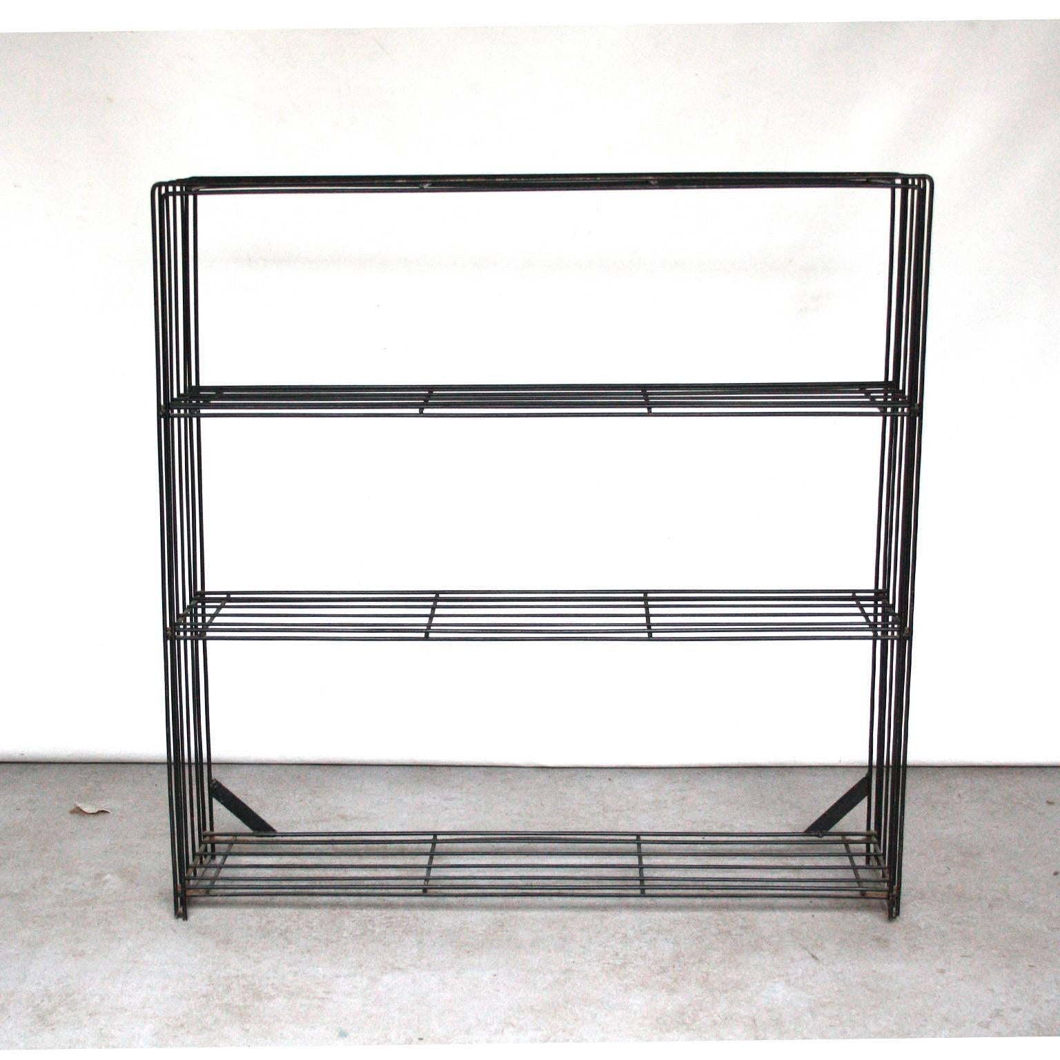 Bookcase by Tjerk Reijenga for Pilastro, Dutch Design.

Black wired metal frame. In original condition. Some wear and rust to the paint at the top. Can be easily repainted, but we like to keep it in original condition.

Because of its relatively