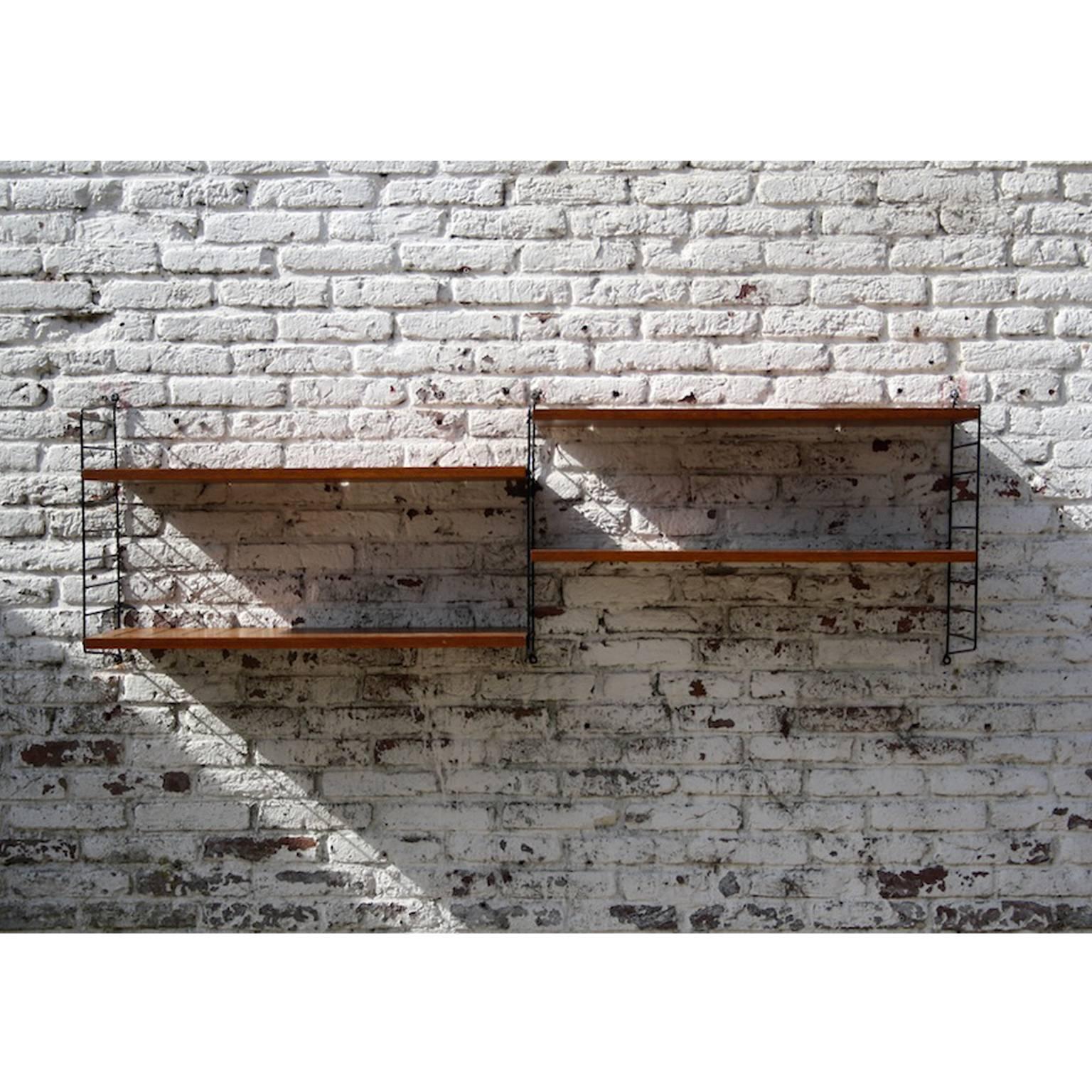 This shelving system with its minimalistic looks, was designed by Swedish architect Nils "Nisse" and his wife Kajsa Strinning in 1949. With its modular construction easily adjustable to your likes.

This system is made of teak and