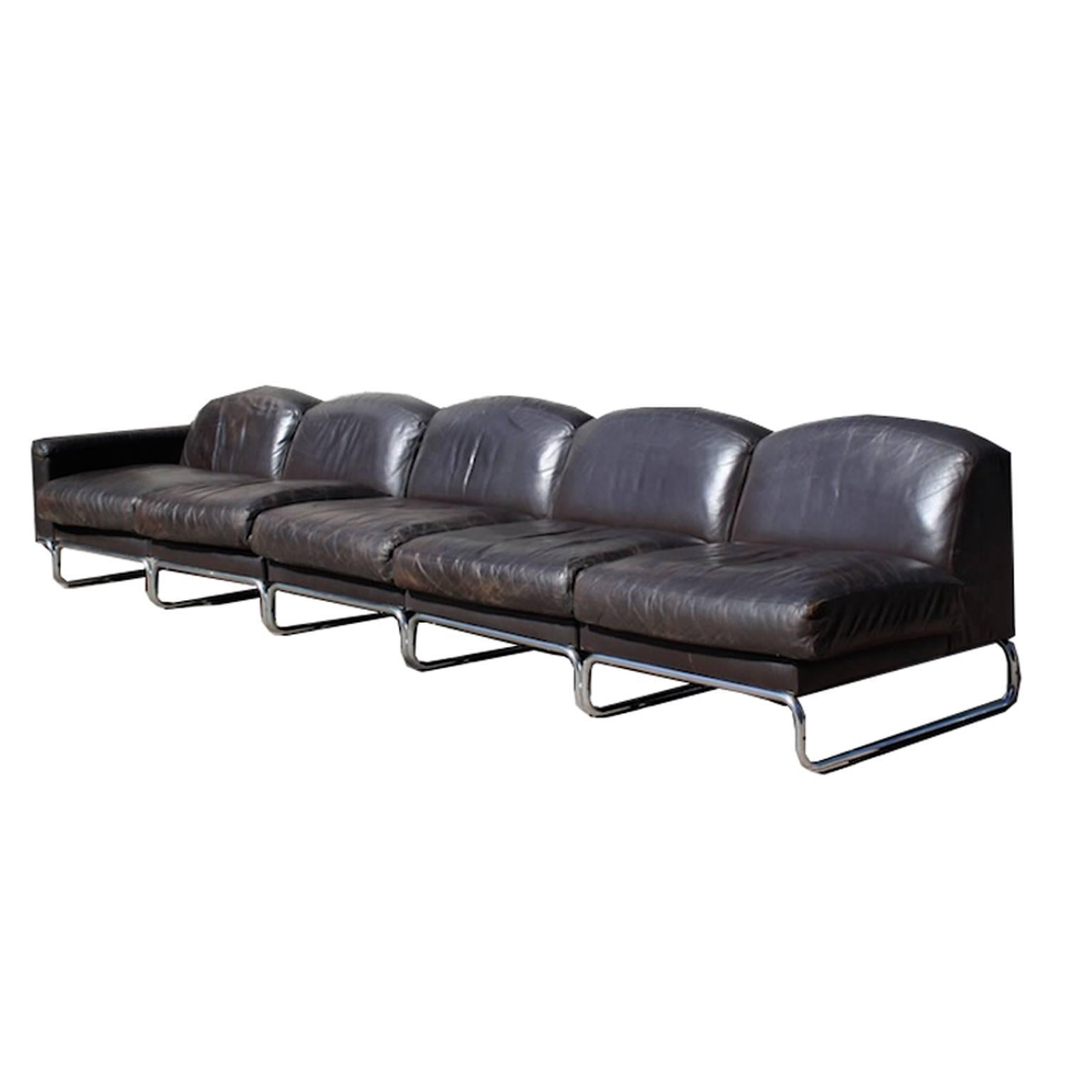 High quality dark brown leather modular sofa on a steel tubular frame by Top form from the 1970s.

Elements can be attached to each other. One element has an armrest. Comes with matching tubular steel magazine stand.

Sofa is in good condition