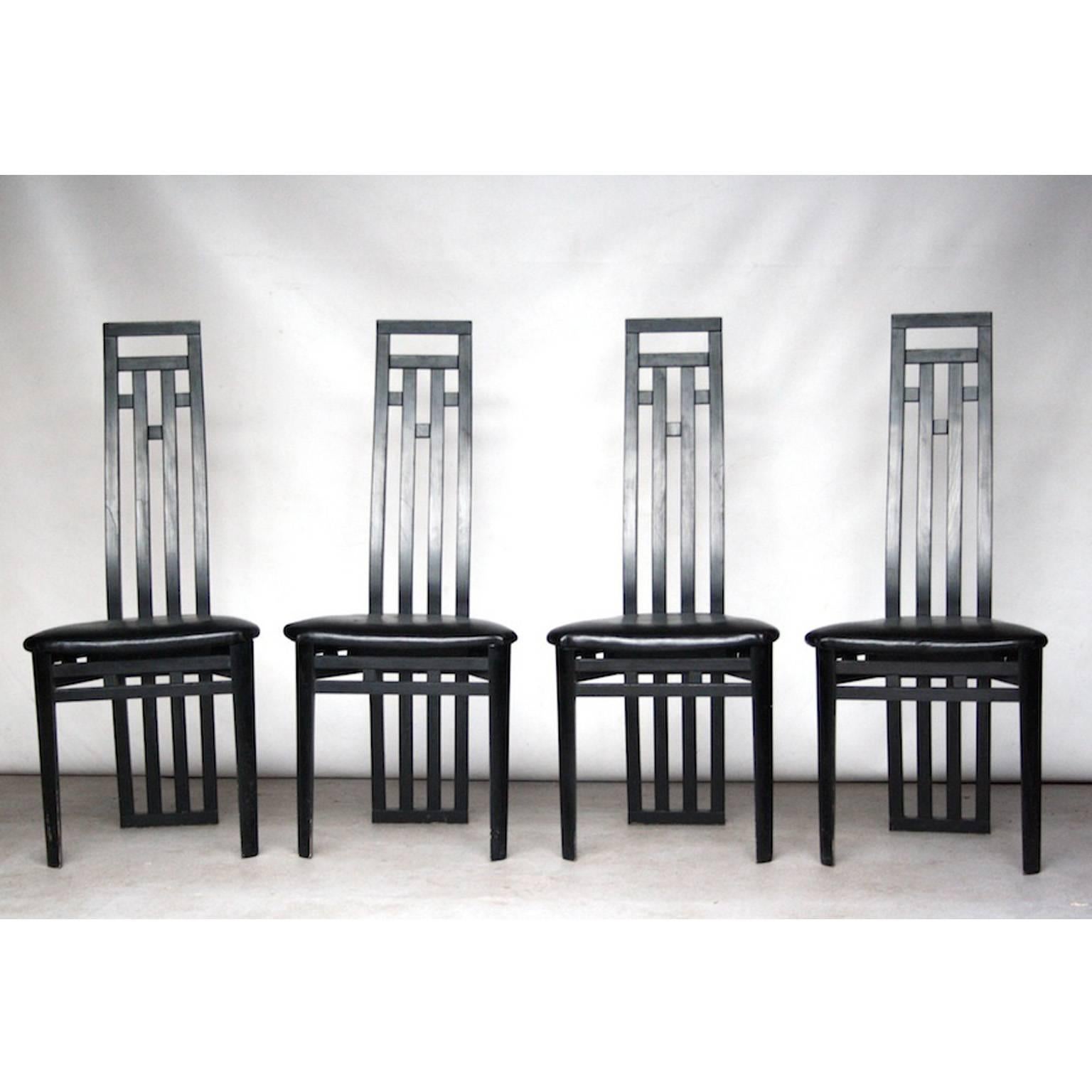 Amazing and rare Italian dining chairs by A. Sibau. The chairs are made of black painted wood with leather seating.

The chairs have a real Italian appearance due to the high sculptured back. We have never seen those chairs before. They are