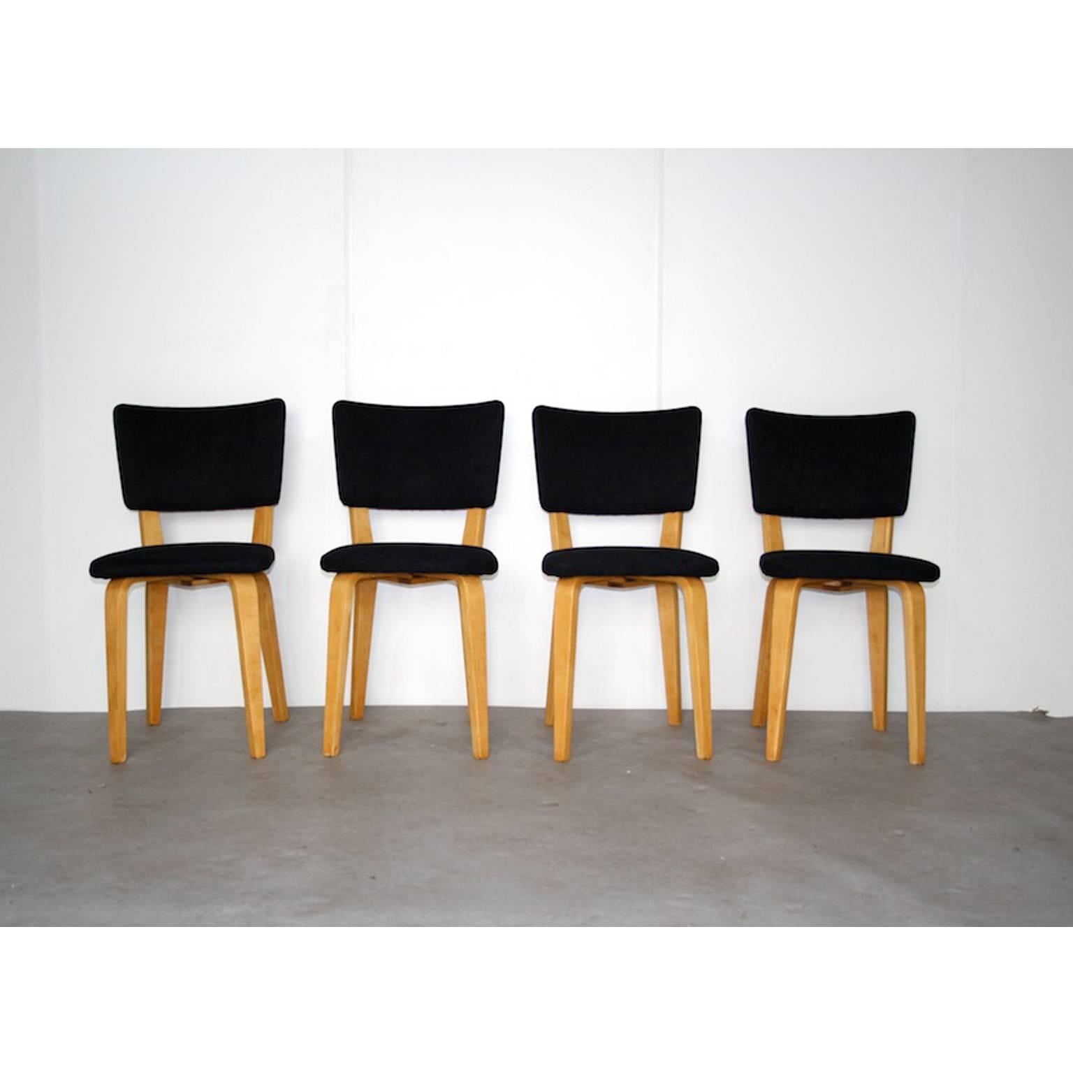 Birchwood plywood chairs with new black upholstery. Designed by Cor Alons for Gouda den Boer in Holland. These chairs have a very nice construction, they exsist of four plywood bars which are attached crosswise and holding the seating and the