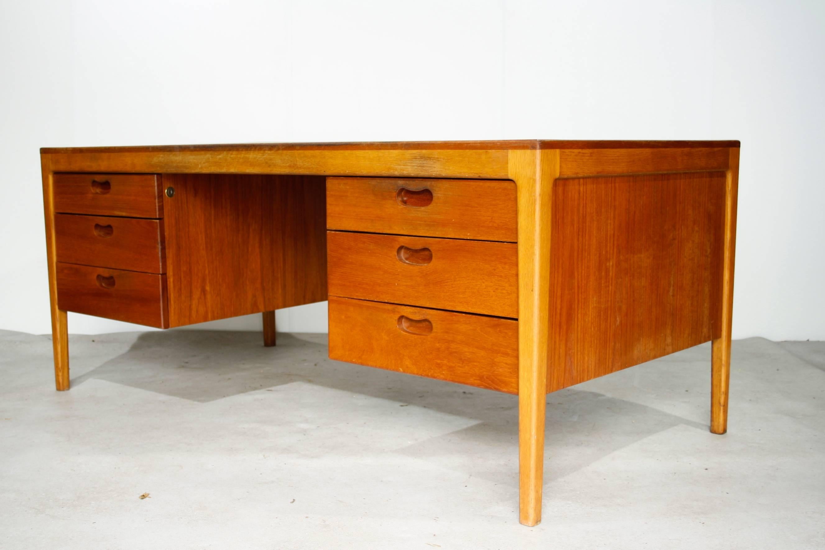 Large and heavy midcentury desk from Denmark with beautiful details.

This high quality desk is partly made of solid teak.

In good condition with normal traces of use.