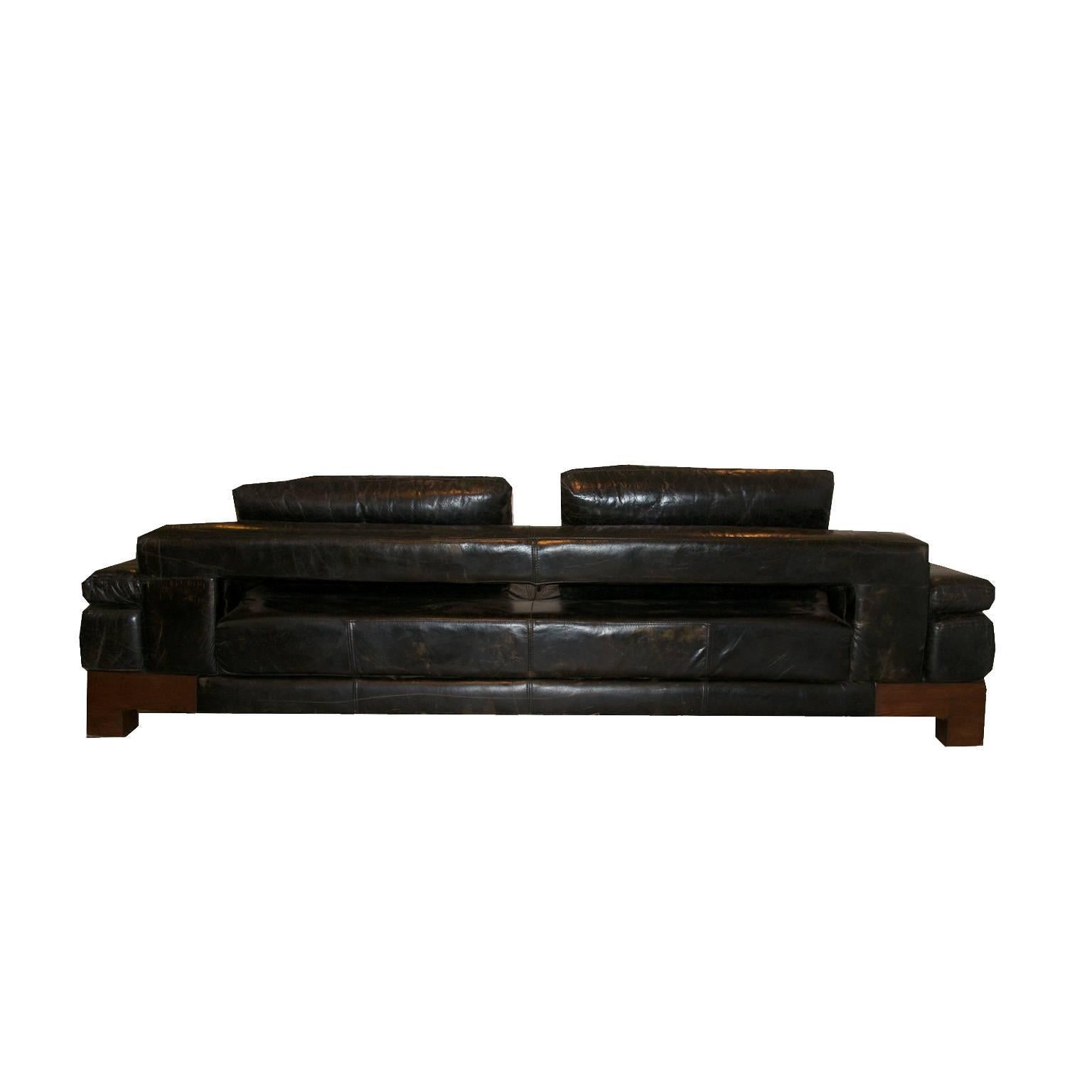 Very stylish black leather sofa.

We still haven’t found its origin, but we think it is Italian made from the 70s. Its base is made of wenge and it is upholstered with thick leather.

We have never seen one before. A very beautiful and exclusive