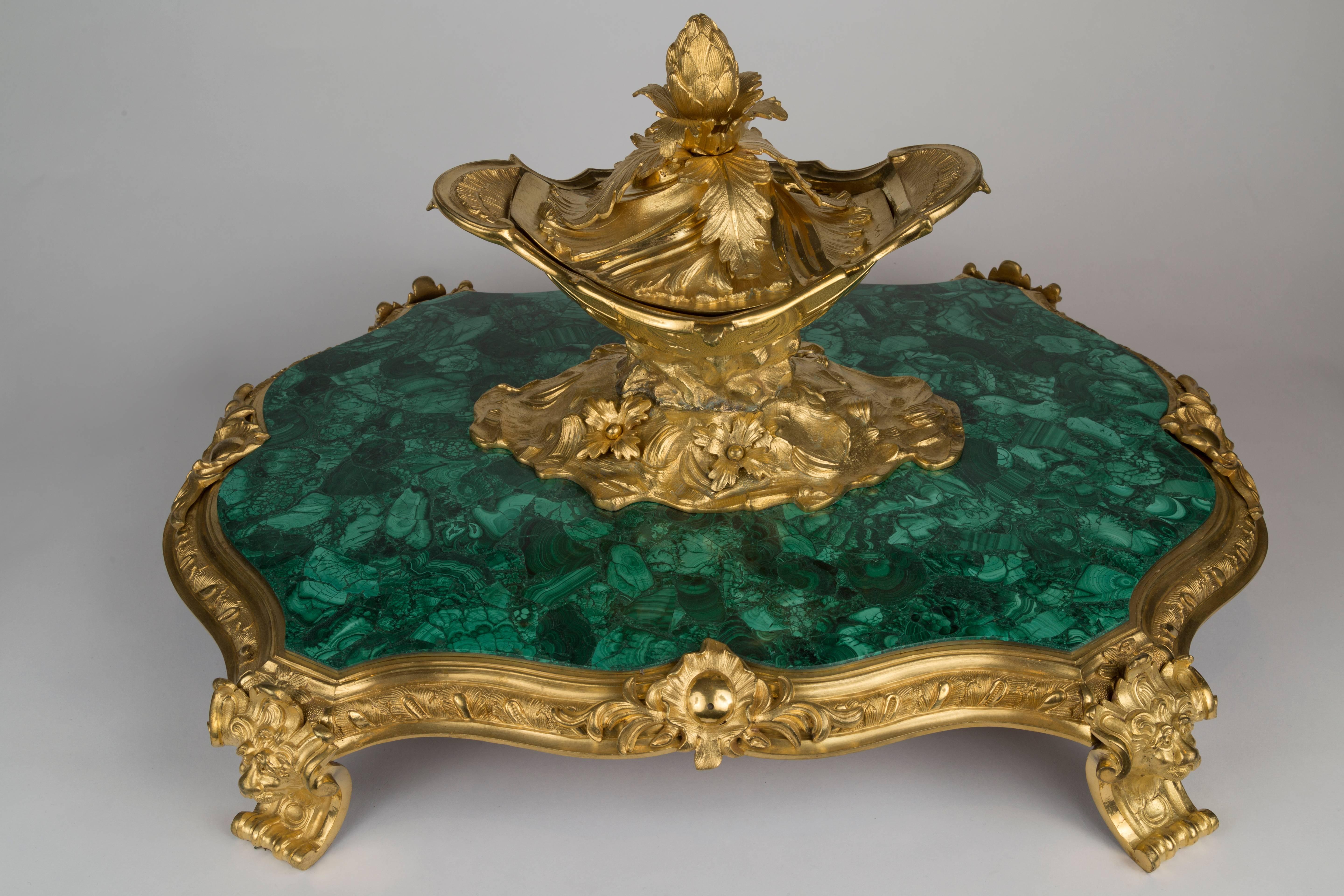 Very large Louis XVI malachite and ormolu-mounted centerpiece
ornate gilt bronze lidded dish with floral leaf motif
accentuated and raised with figural lion mounts
France, 19th century
Measures: H 15 in. x 25 in. x 19 in.