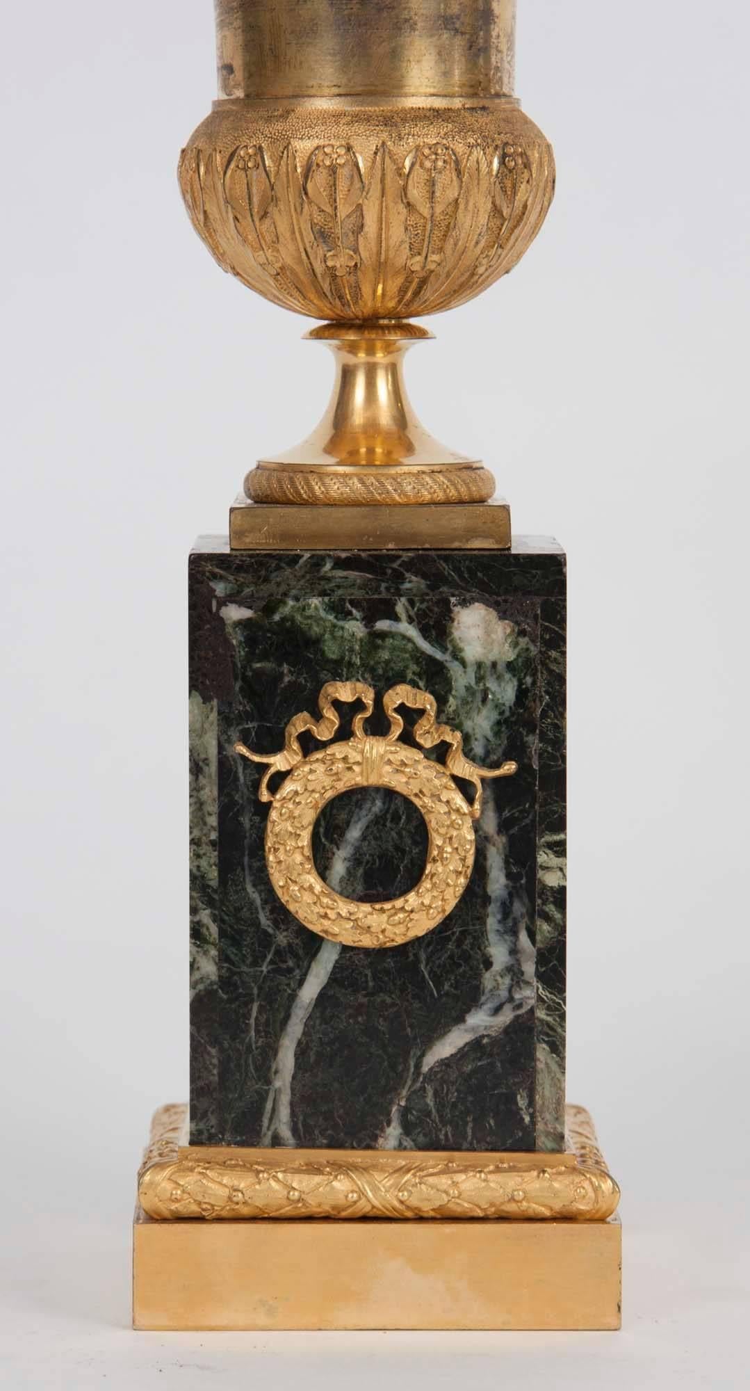 Gilt bronze vases mounted on verde antico marble base, circa 1810.