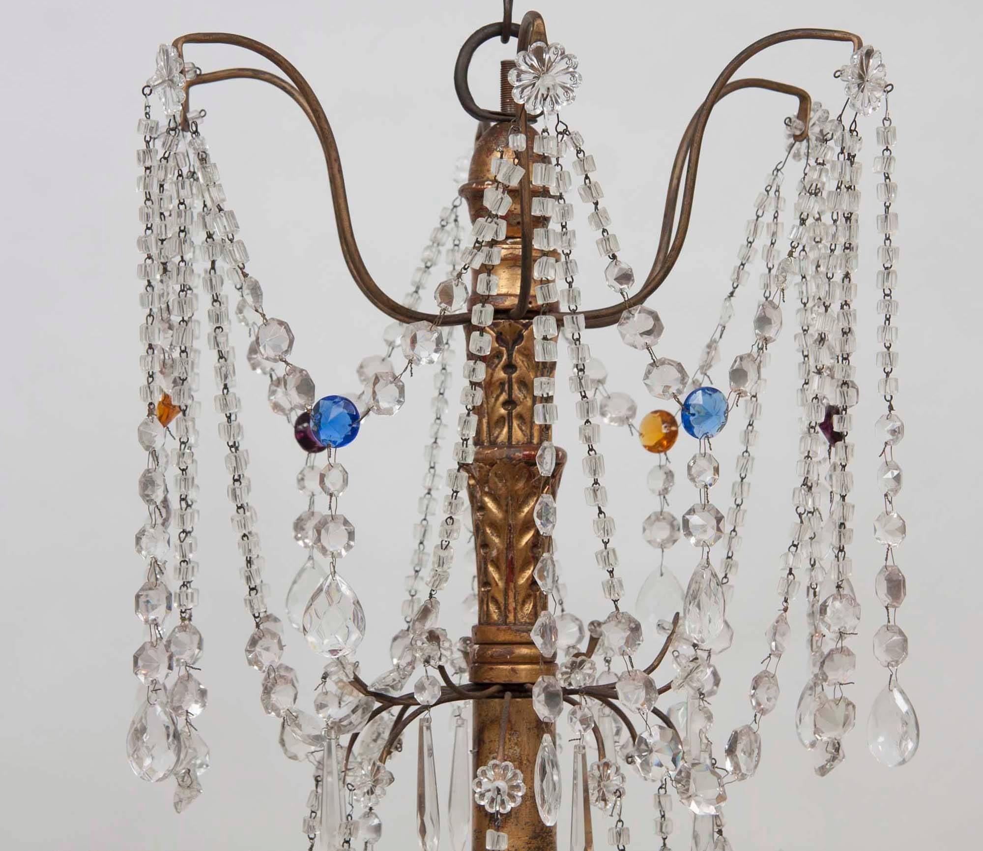 Italian eight-light chandelier with gilt iron S-scrolled arms joined by clear garlands accented by dropped crystals and rosettes. Chandelier is electrified.