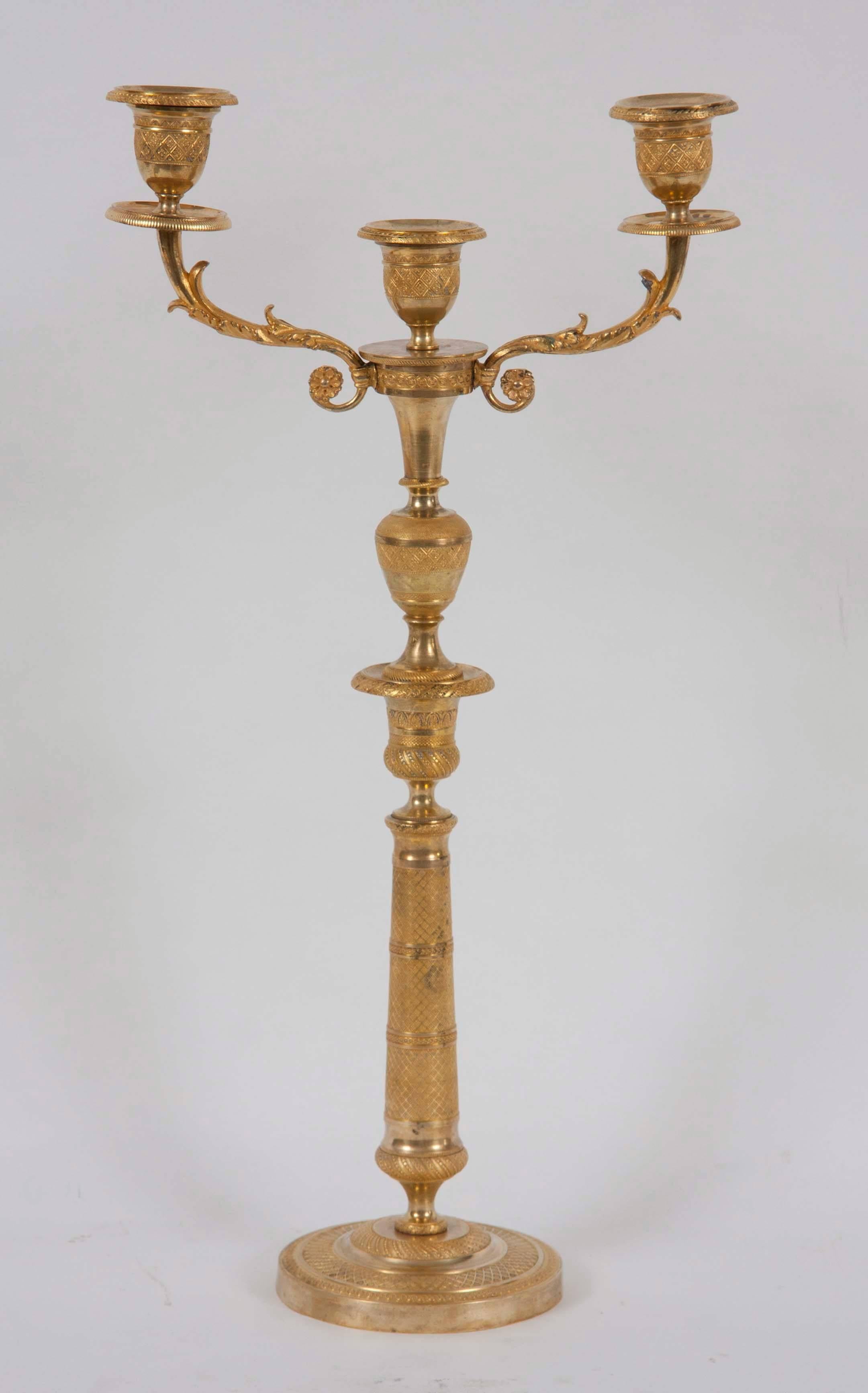 Pair of French gilt bronze candlesticks
three-light candleholder.
France, 19th century.
  