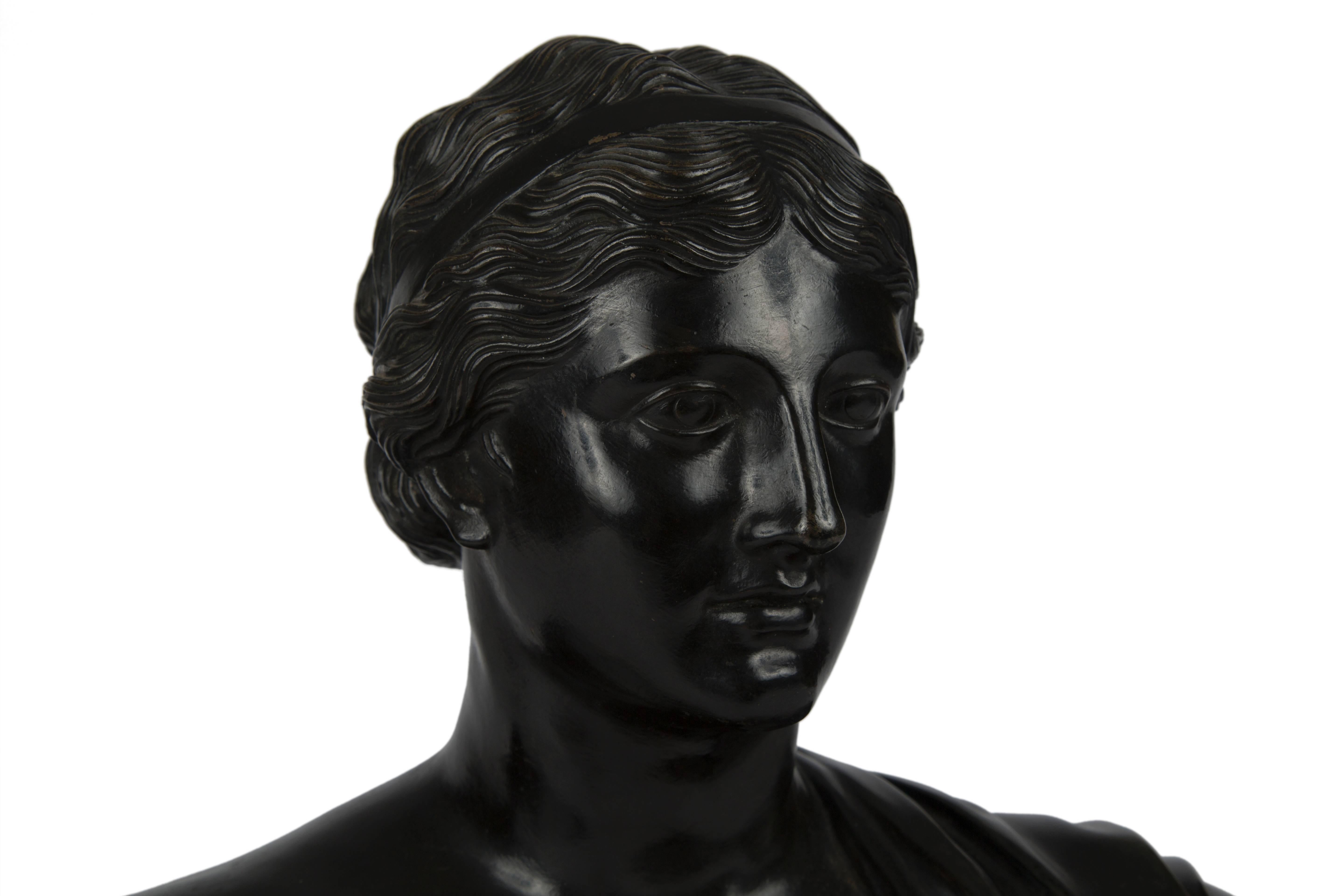 Italian patinated bronze bust of a classical woman. Mounted on giallo di siena and nero di belgio base, Grand Tour, 19th century.