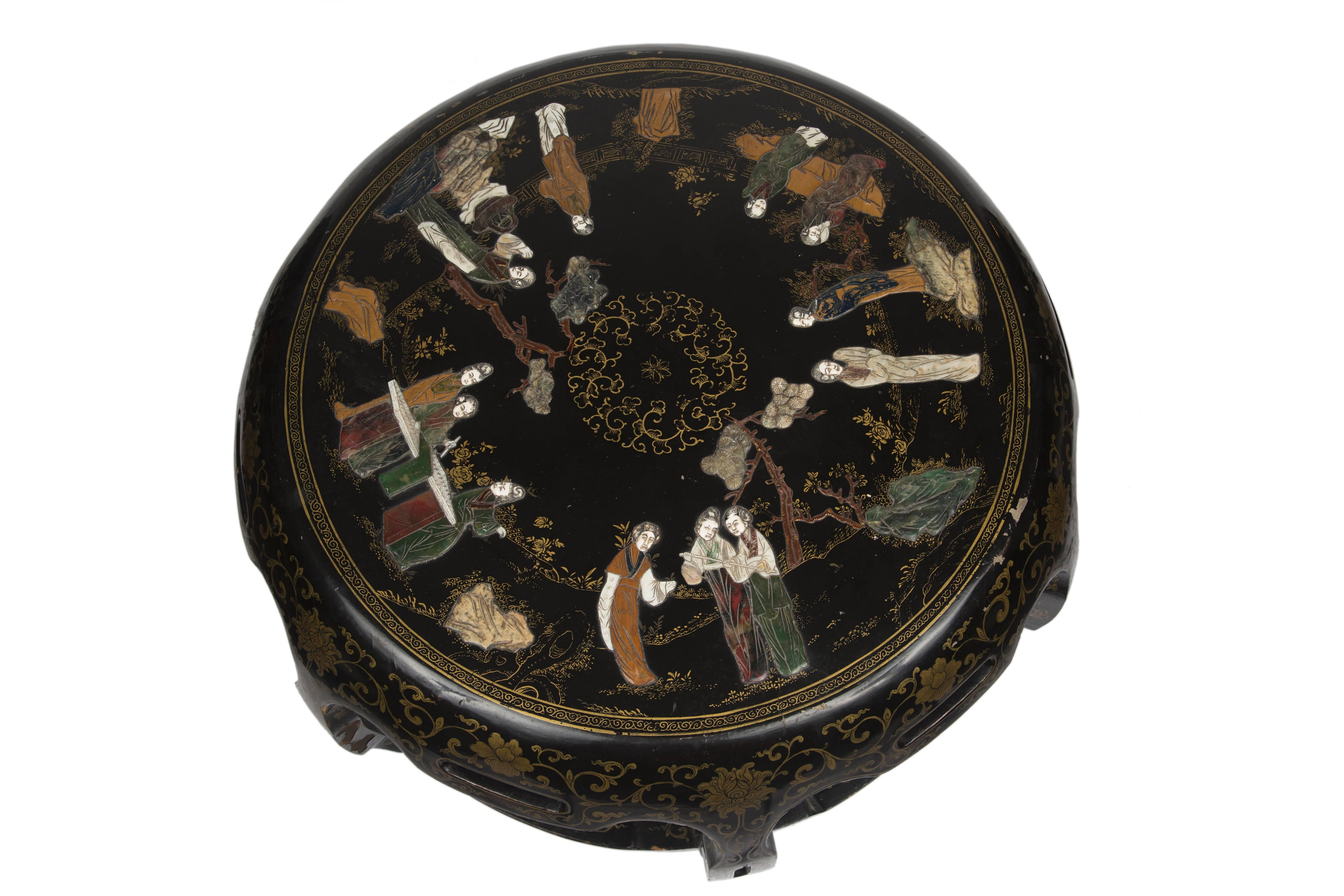 Chinese, 19th century.
Carved black lacquer table in round ruyi shape. Figural scenes inlaid with hardstone carvings made of Jade, mother-of-pearl, amethyst, tiger eye, rose quartz, soapstone, and several others. Accented with elaborately painted