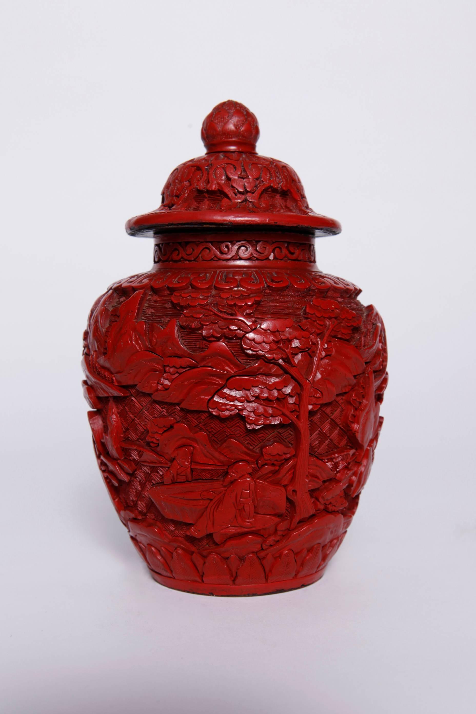 Pair of Chinese cinnabar covered ginger jars
decorated with carved figural landscapes
Late Qing dynasty
Measures: H 8 in. (20.3 cm).