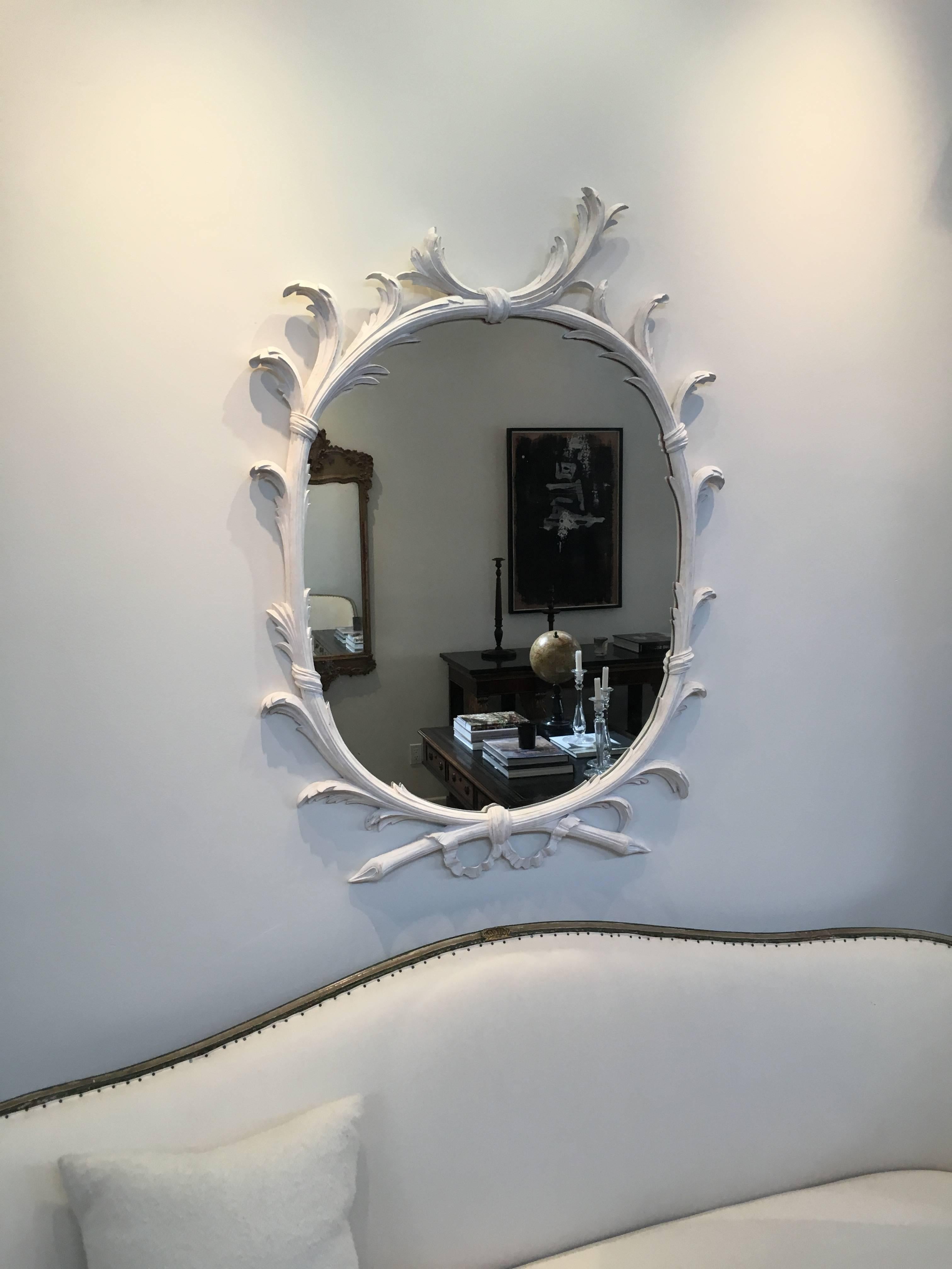 A pair of 1930s whimsical carved mirrors with new gesso finish.