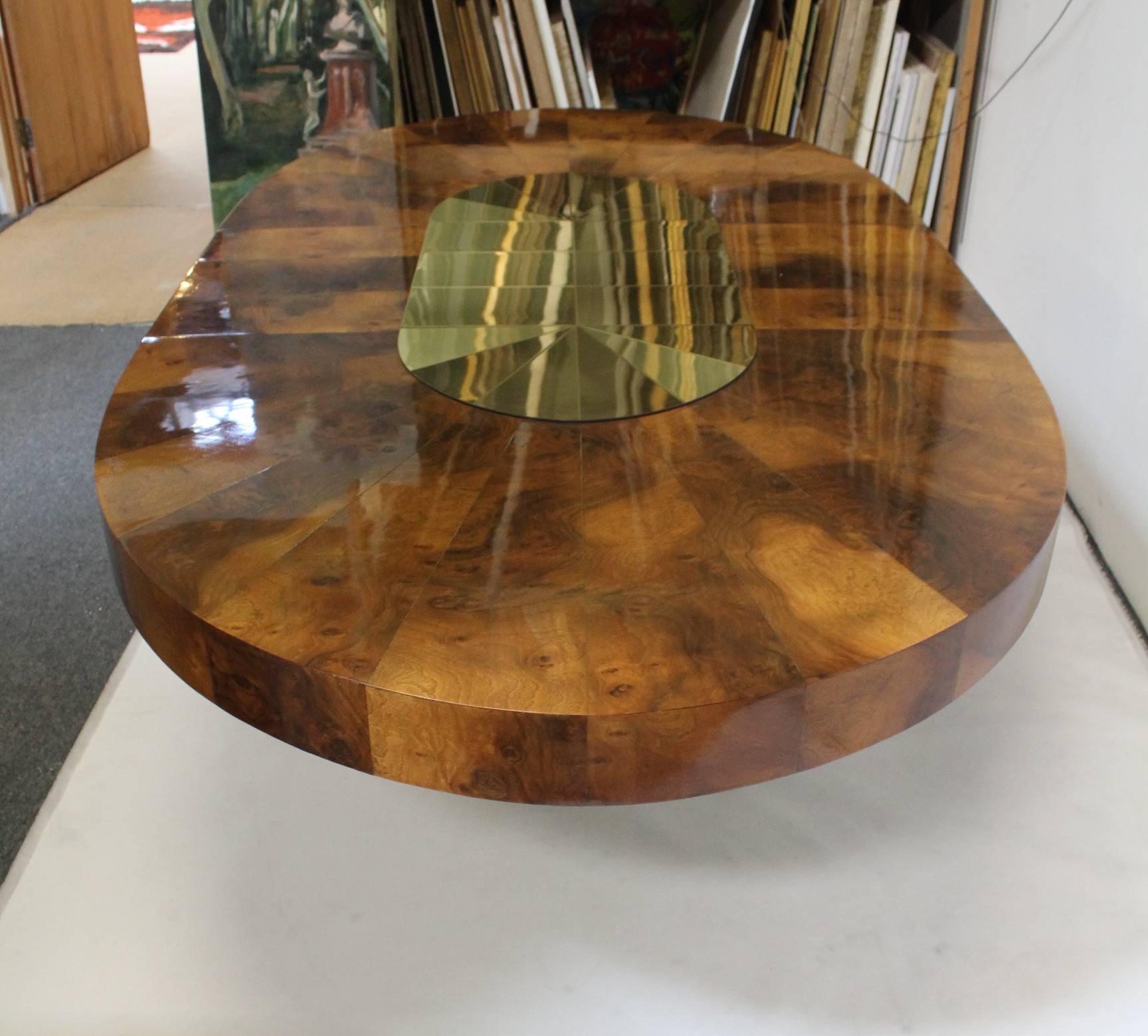 Stunning dining table by Paul Evan with beautiful sunburst brass and wood design. The wood and brass positively glow, circa 1970s.

Table presents very well despite wear consistent with age and use; scratches to middle leaf extender, small dings