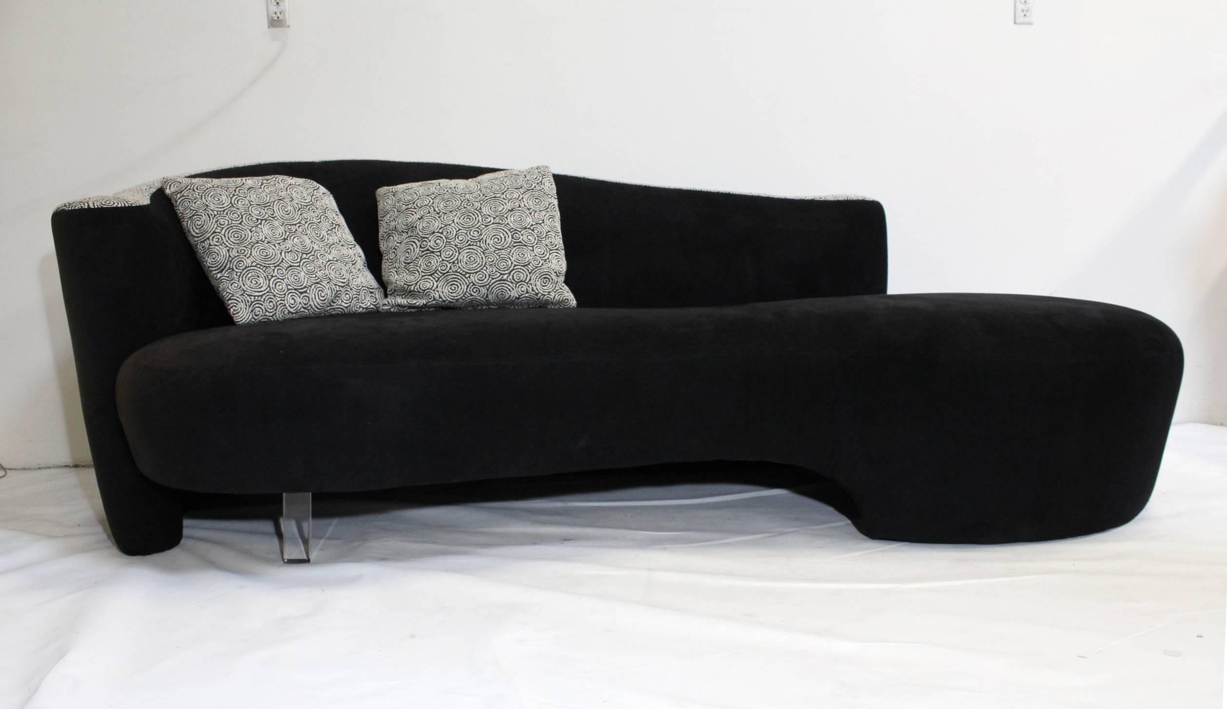 Beautiful pair of iconic style of Vladimir Kagan sofas for Weiman furniture. Sensual serpentine/cloud shape, raised on Lucite legs. Two-tone upholstery, woven gray on gray spiral pattern and black suede-like material.

Some sun fading on left side