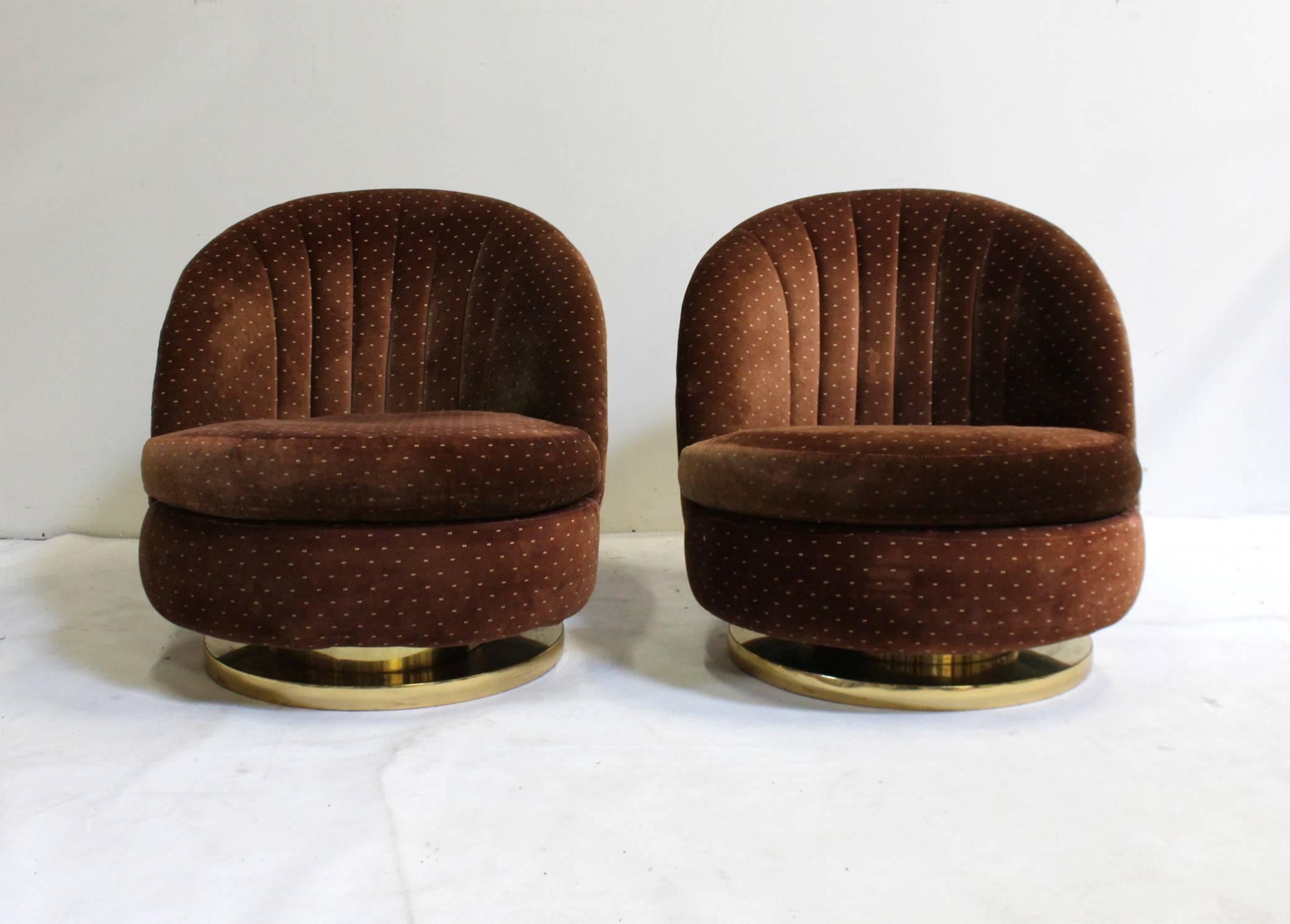 Pair of Milo Baughman for Thayer Coggin swivel and rock lounge chairs from the 1970s with original tag and upholstery. Upholstery is worn and damaged and needs to be re-upholstered. Base shows signs of wear but presents well.