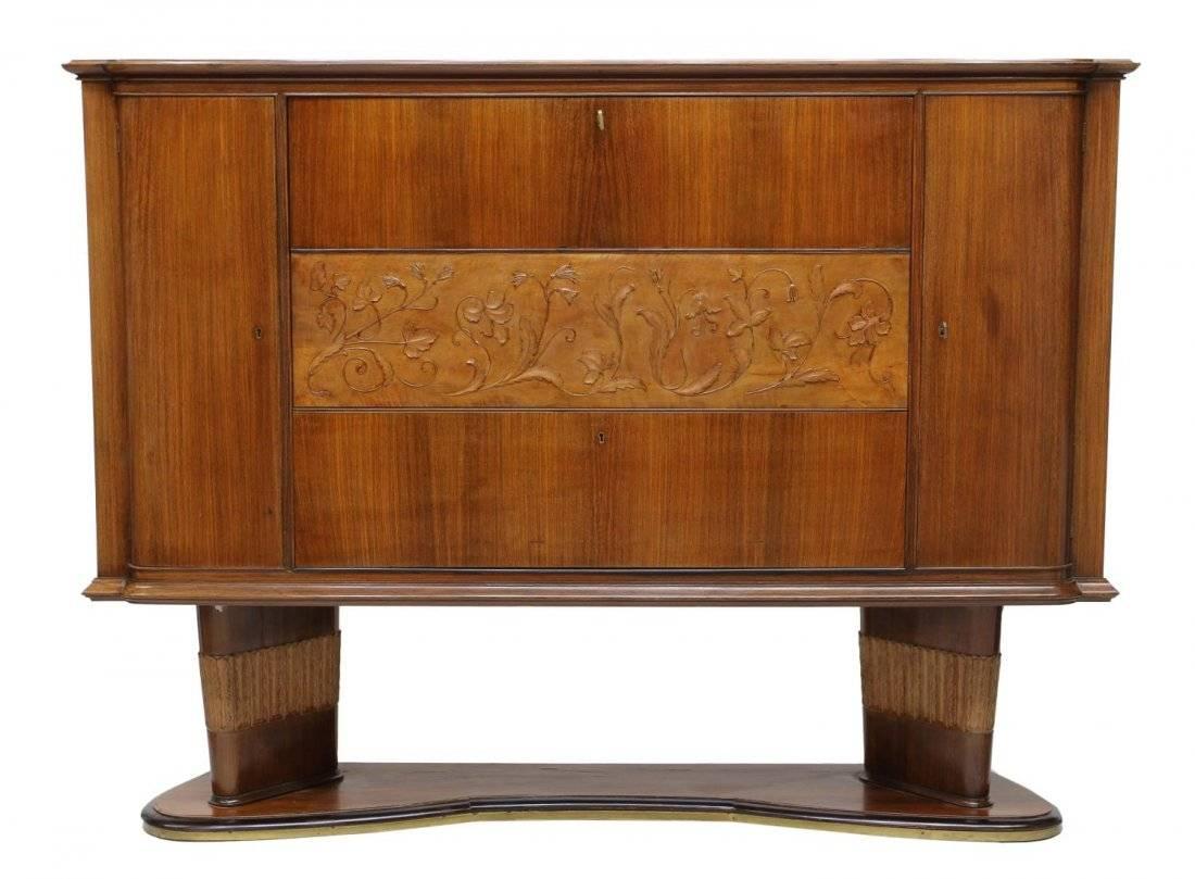 An Italian Mid-Century Modern bar/cabinet from the 1950s, designed by Vittorio Dassi (Milan, 1893-1973). It features two cabinets flanking a central floral carved reserve. Drop top opens to reveal compartments with drawers, one having a mirrored