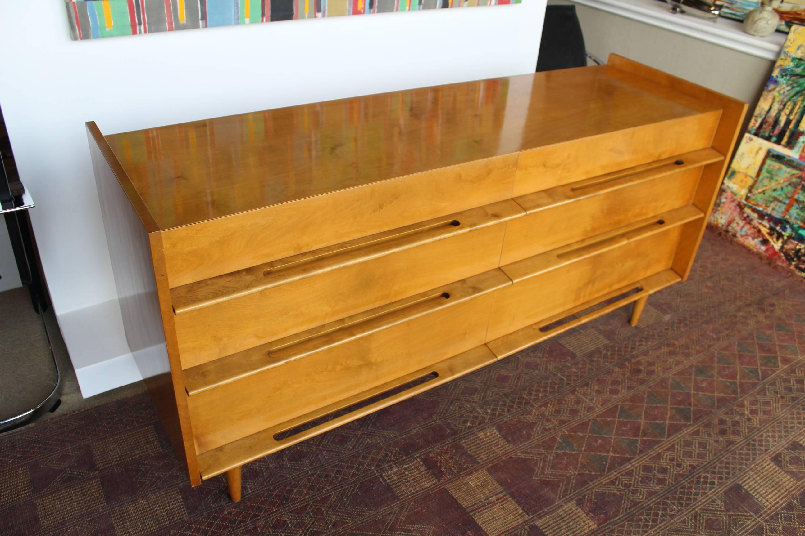 Edmond Spence, Coronation Collection for the Walpole Furniture Company six-drawer dresser from 1953. The implied volume of the bureau with its set back drawer faces, extended sideboards, tapered legs, sculpted pulls and raised edges give this