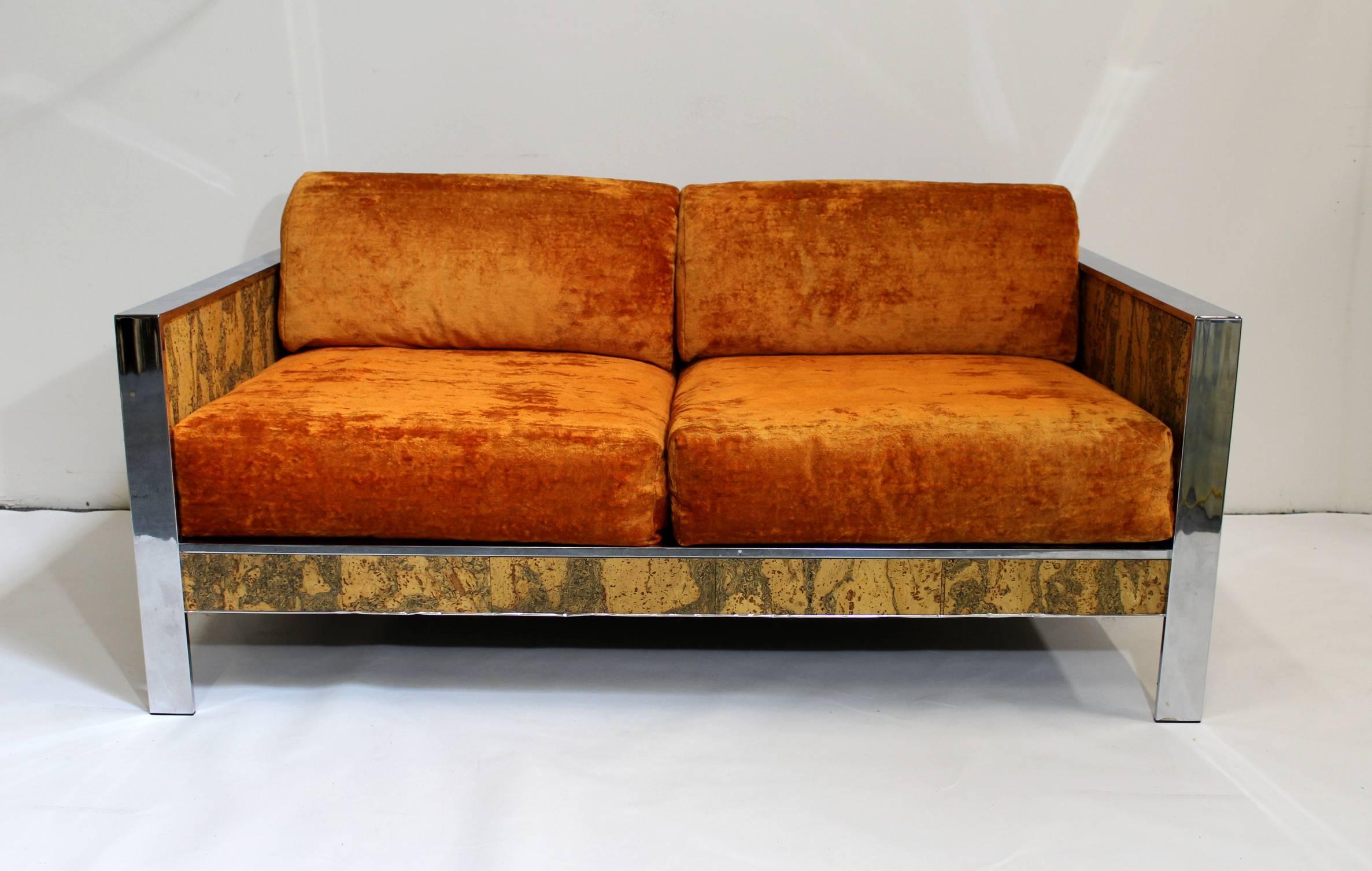 1970s Milo Baughman style sofa with beautiful cork and chrome body and amazing orange crushed velvet cushions! Incredible decorative piece that would really set off a room.
     