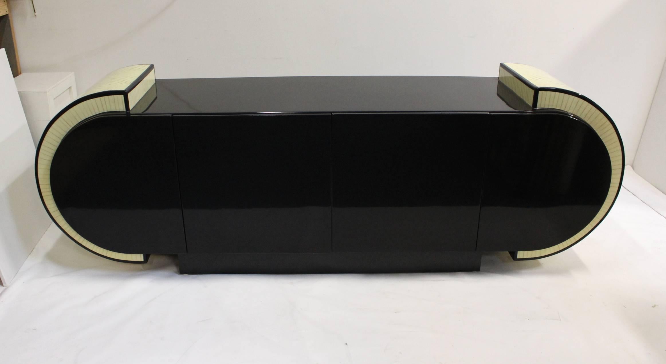 Massive (8 foot wide) black lacquered Pierre Cardin style dresser/buffet with four doors and two drawers inside. Shiny black body with faux inlaid bone sides. Amazing, one of a kind decorative piece.