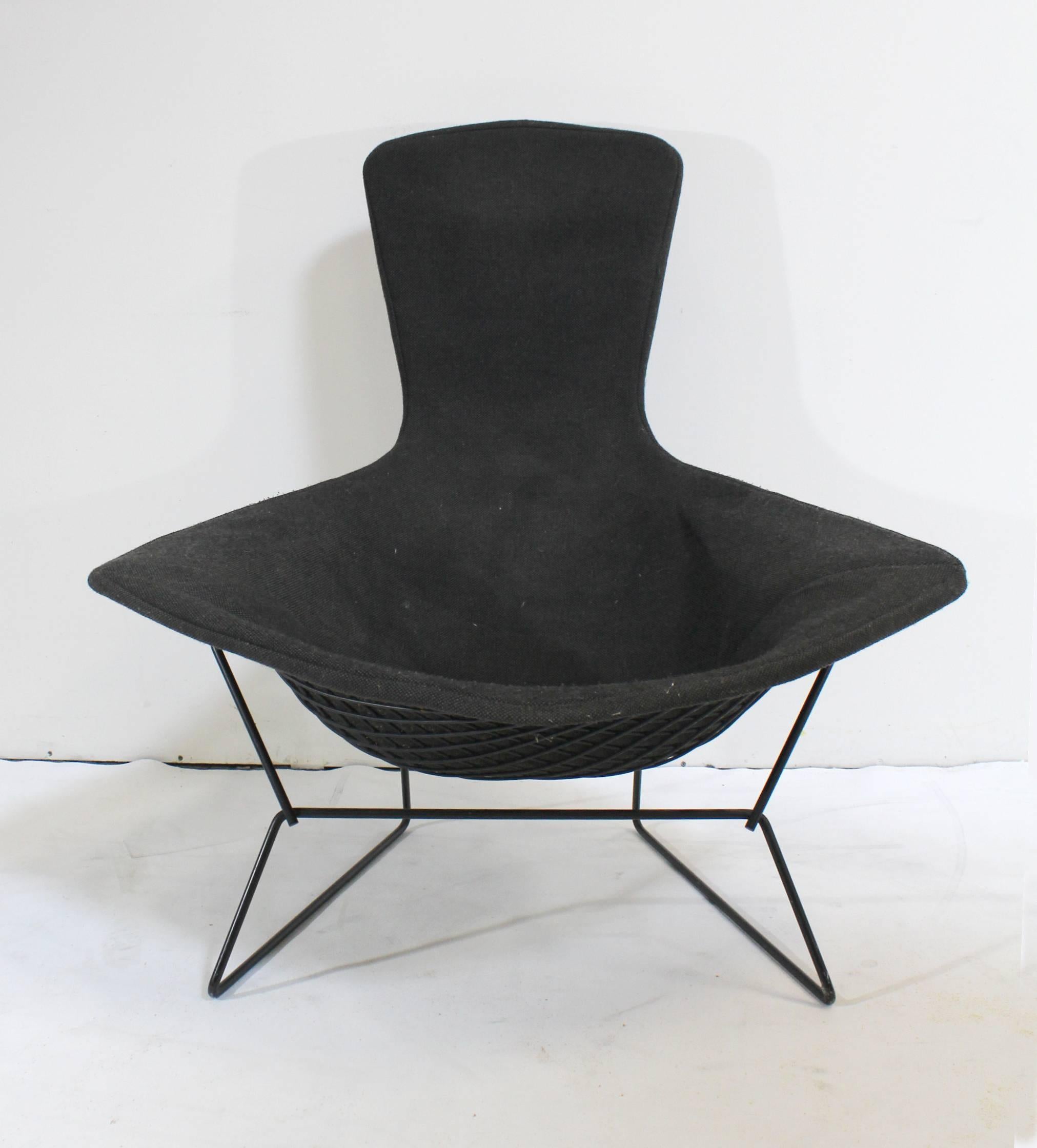 The 'Bird' chair was designed by Harry Bertoia for Knoll in 1952. This piece probably dates from the 1970s. Classic Mid-Century accent chair. Charcoal black removable upholstery on black frame. Ottoman has original Knoll tag (see