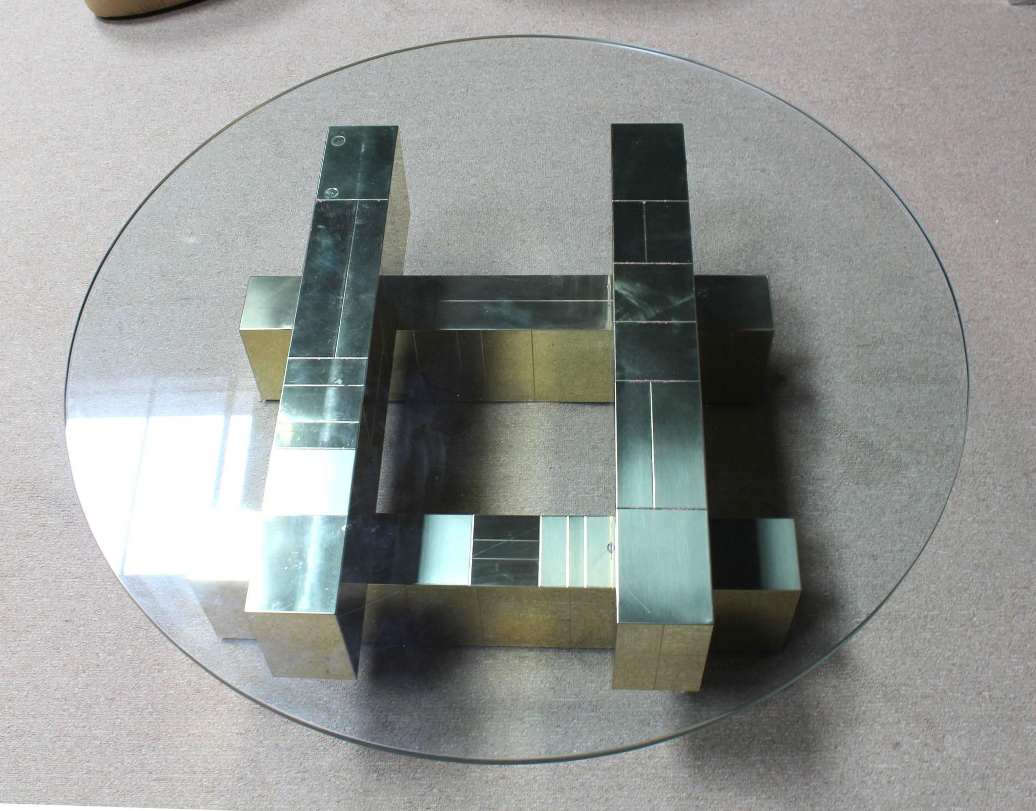A vintage brass coffee and cocktail table with square glass top, produced by Paul Evans in the 1970s in his iconic 'cityscape' style of tiled brass plates and sharp architectural lines. Good vintage condition with age appropriate wear and patina,