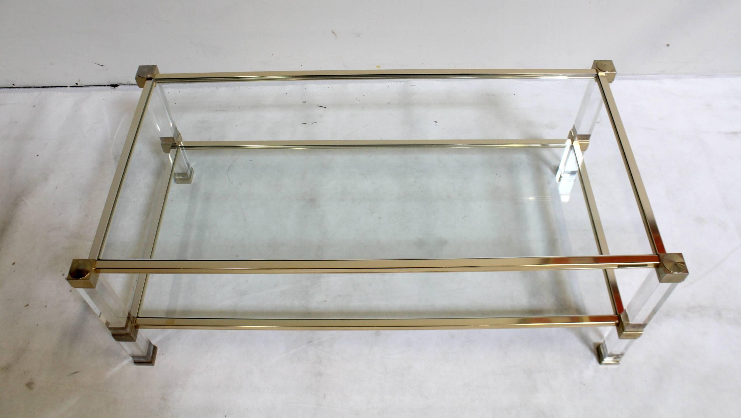 1970's brass-plated metal, lucite and glass coffee table signed Pierre Vandel, Paris.

Glass is in perfect condition, table shows small signs of wear.

