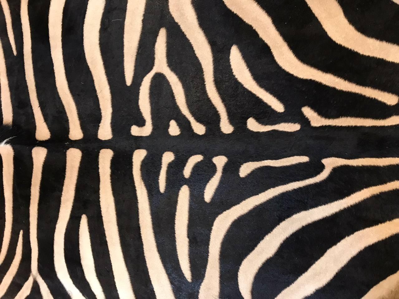 Beautiful grade “A” zebra skin rug lined with canvas and finished with leather trim.
Measures: 100