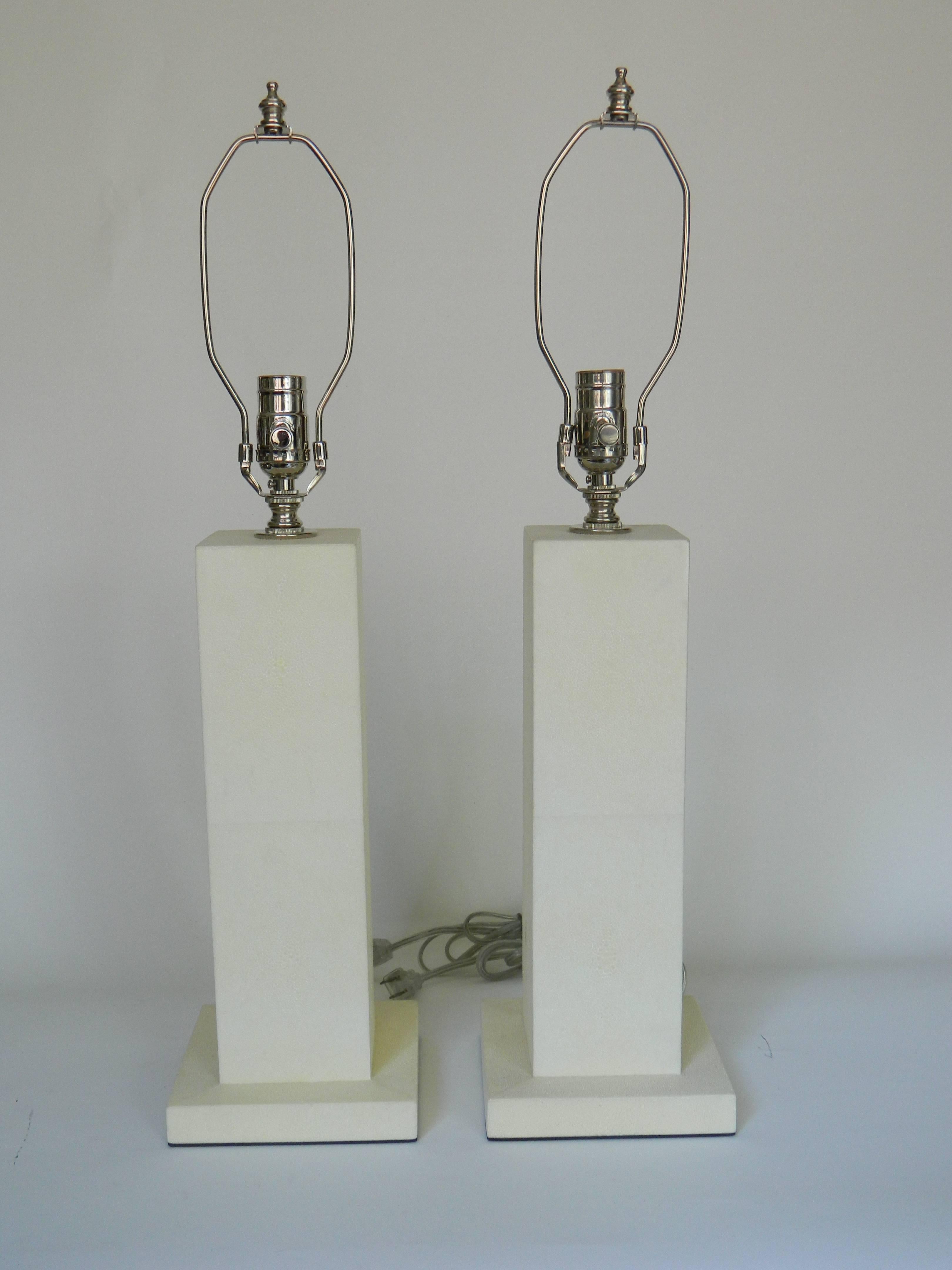 Ivory shagreen table lamps.
Size: 15''H excluding the socket, base: 6.25''square.