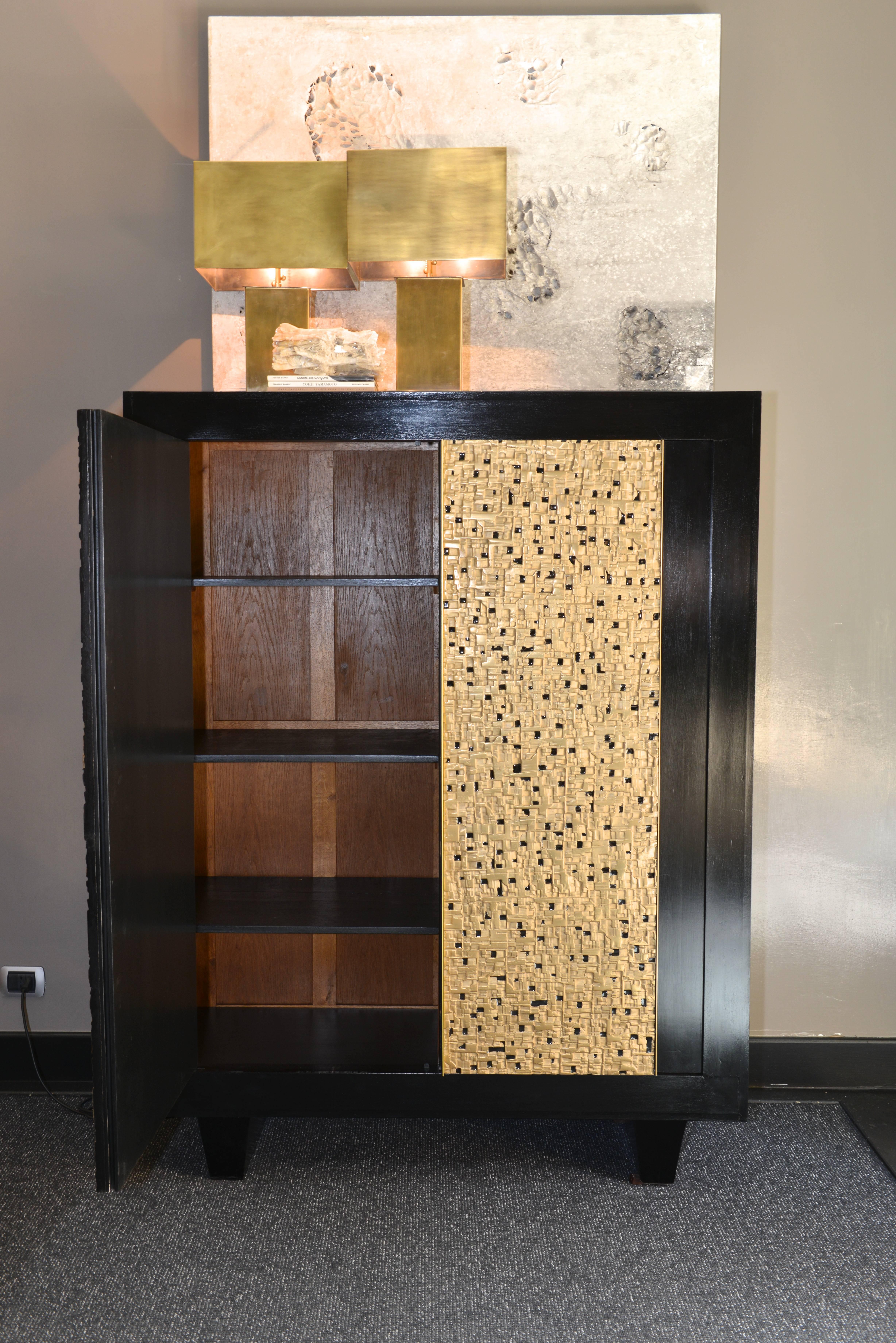 Original vintage structure in wood that has been re-ebonized. The doors have been decorated with sculptural, bronze powder coated resin panels, with enamel details.