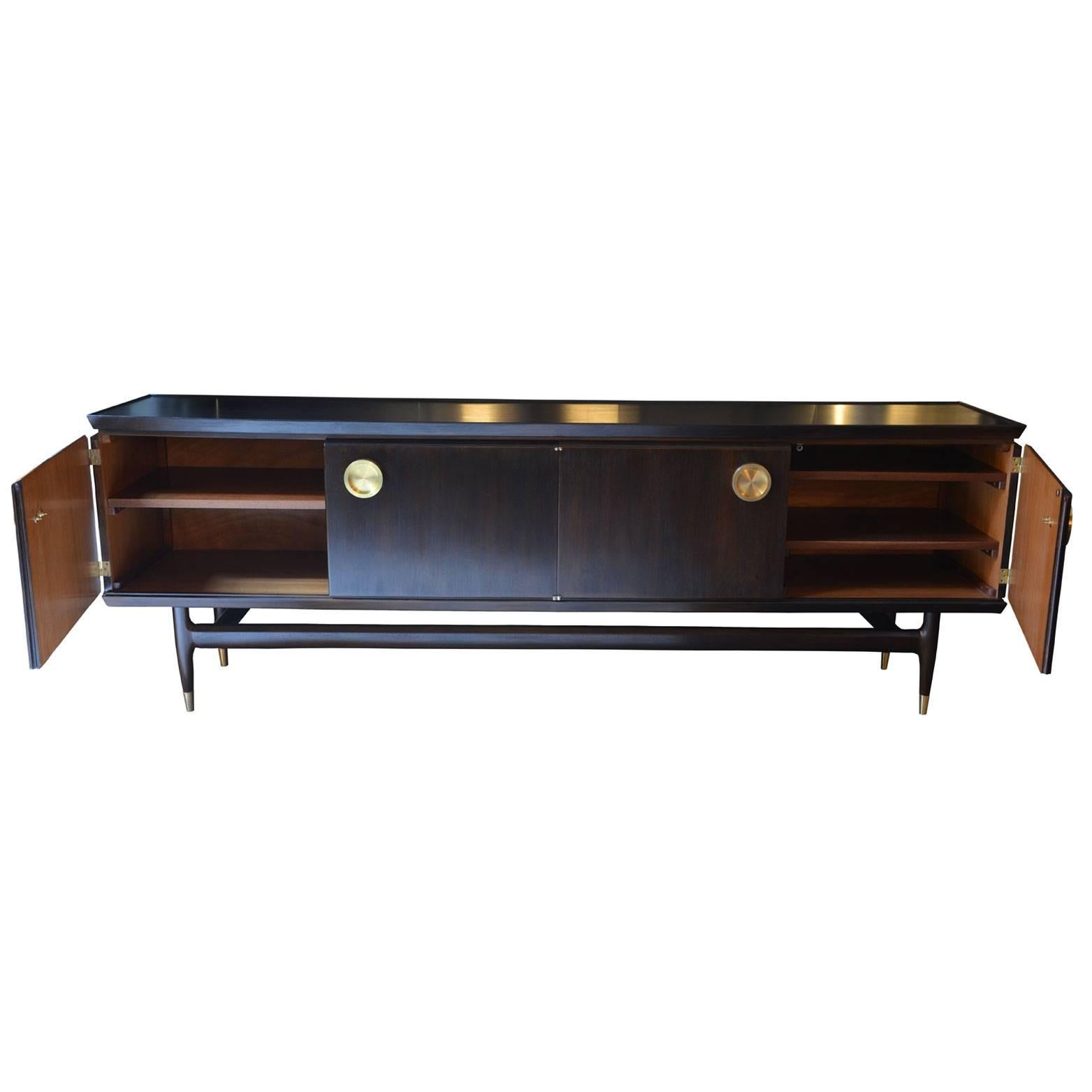 We have revisited this stunning French credenza, changing the original wooden door knobs with beautifully worked circular brass handles and adding the brass tips at the base of the legs. The inside shelves can be removed.