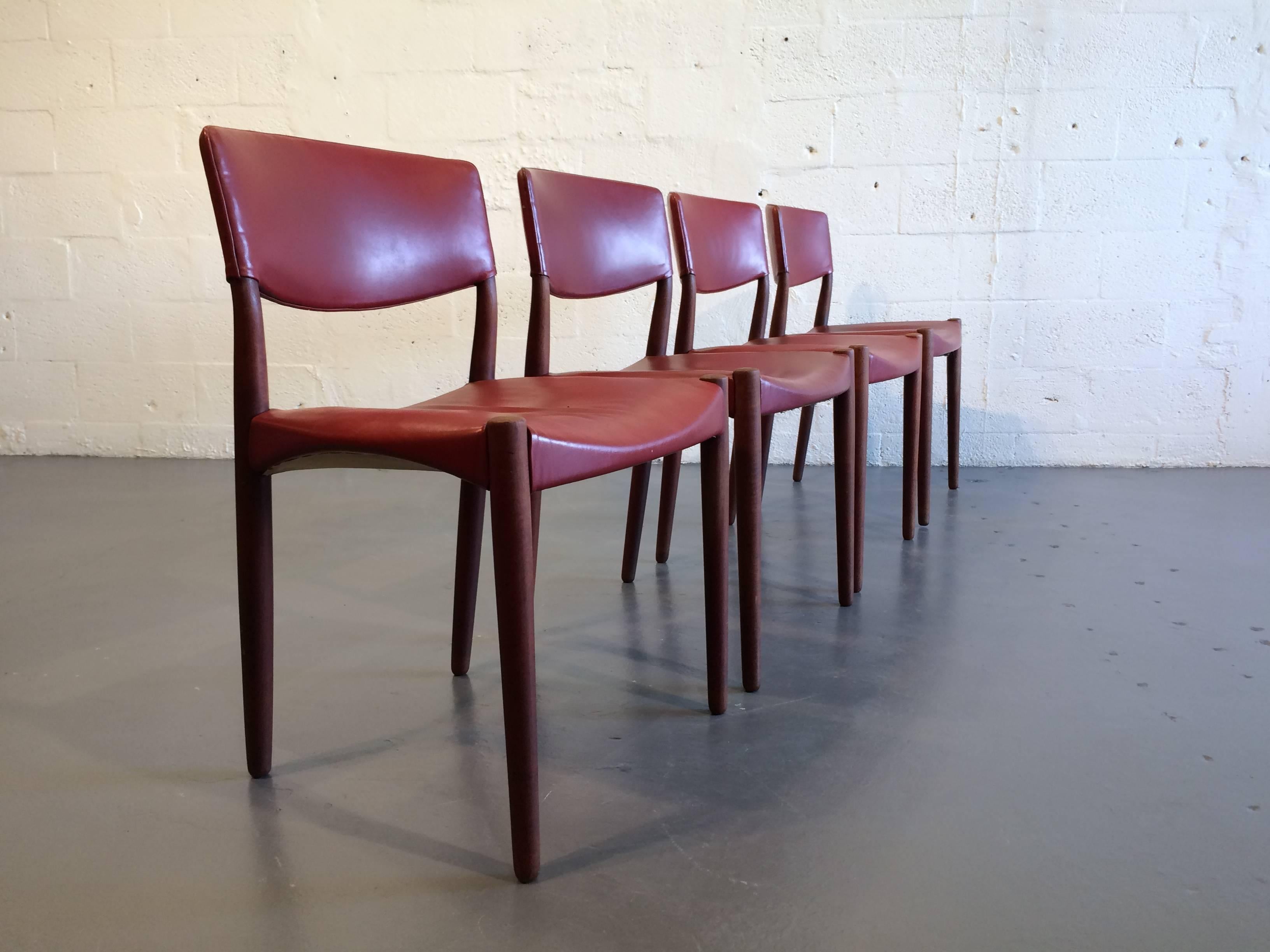 Set of eight dining chairs by Ejner Larsen & Aksel Bender Madsen. Teak frames and original red leather.