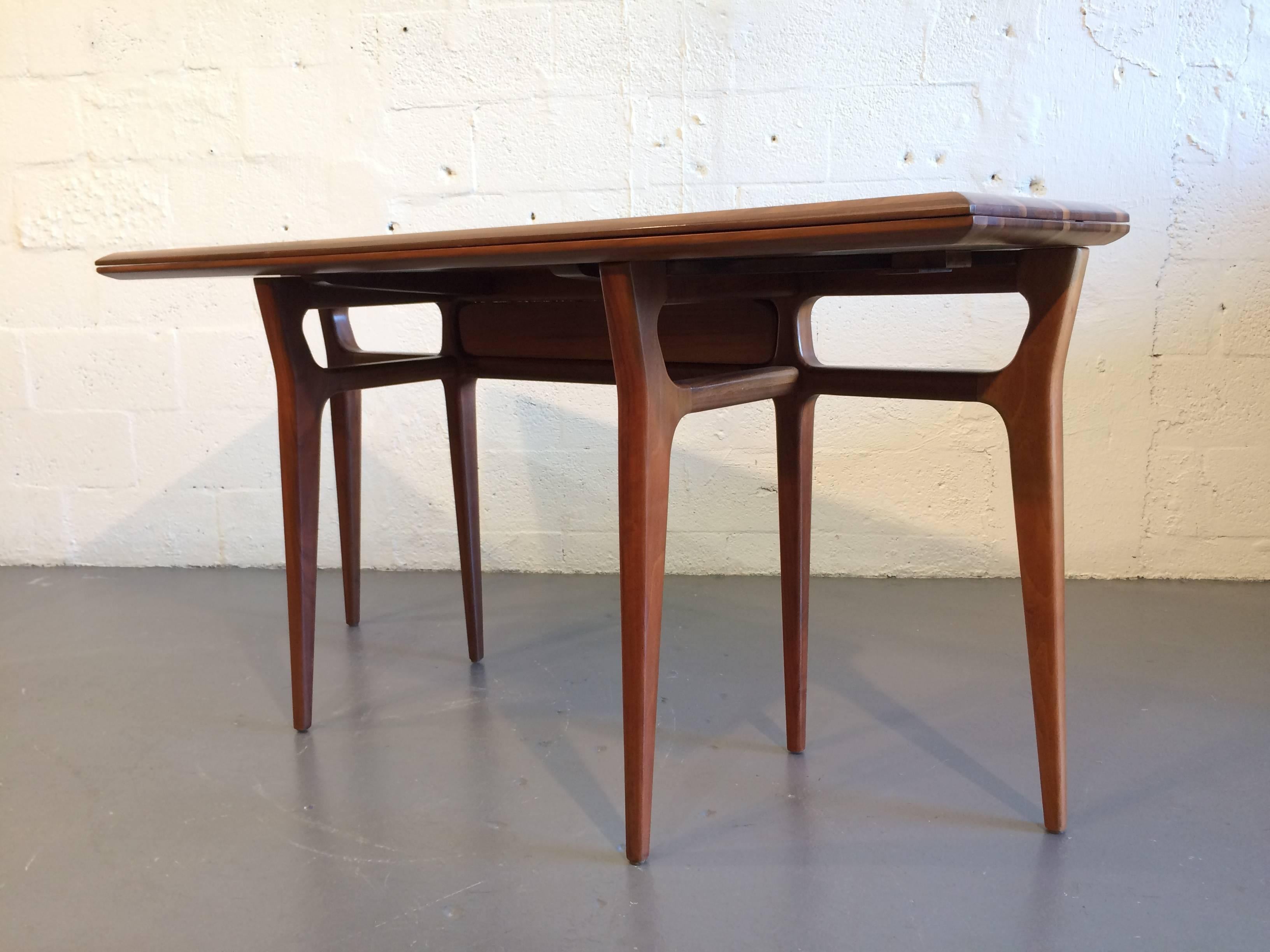 Solid walnut flip-top console table. Can be used as a dining table. Opened tabletop measures 36.25 inches deep, 60 inches long and 29.25 inches high.