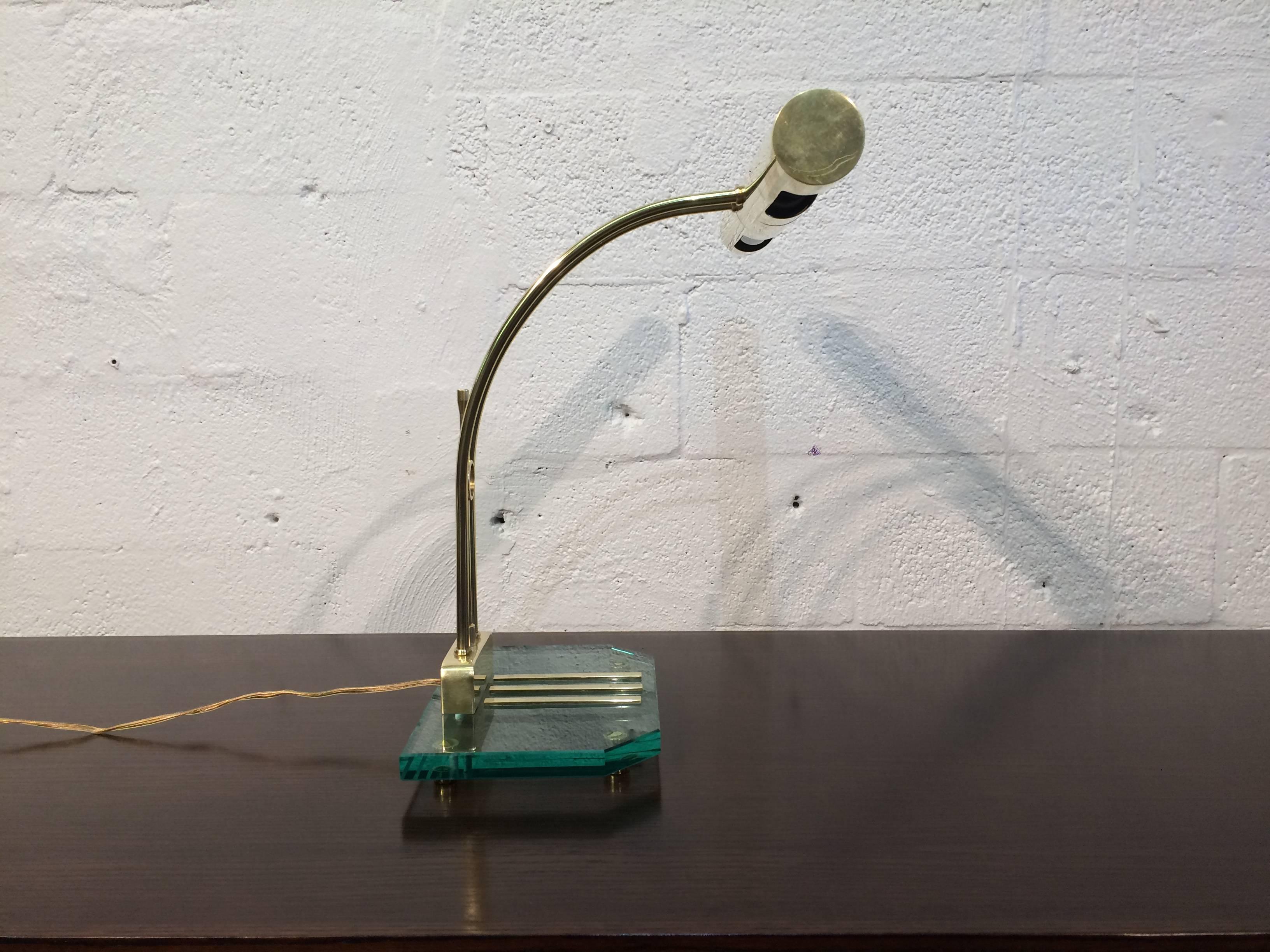 Well crafted designer table lamp made of brass and glass.