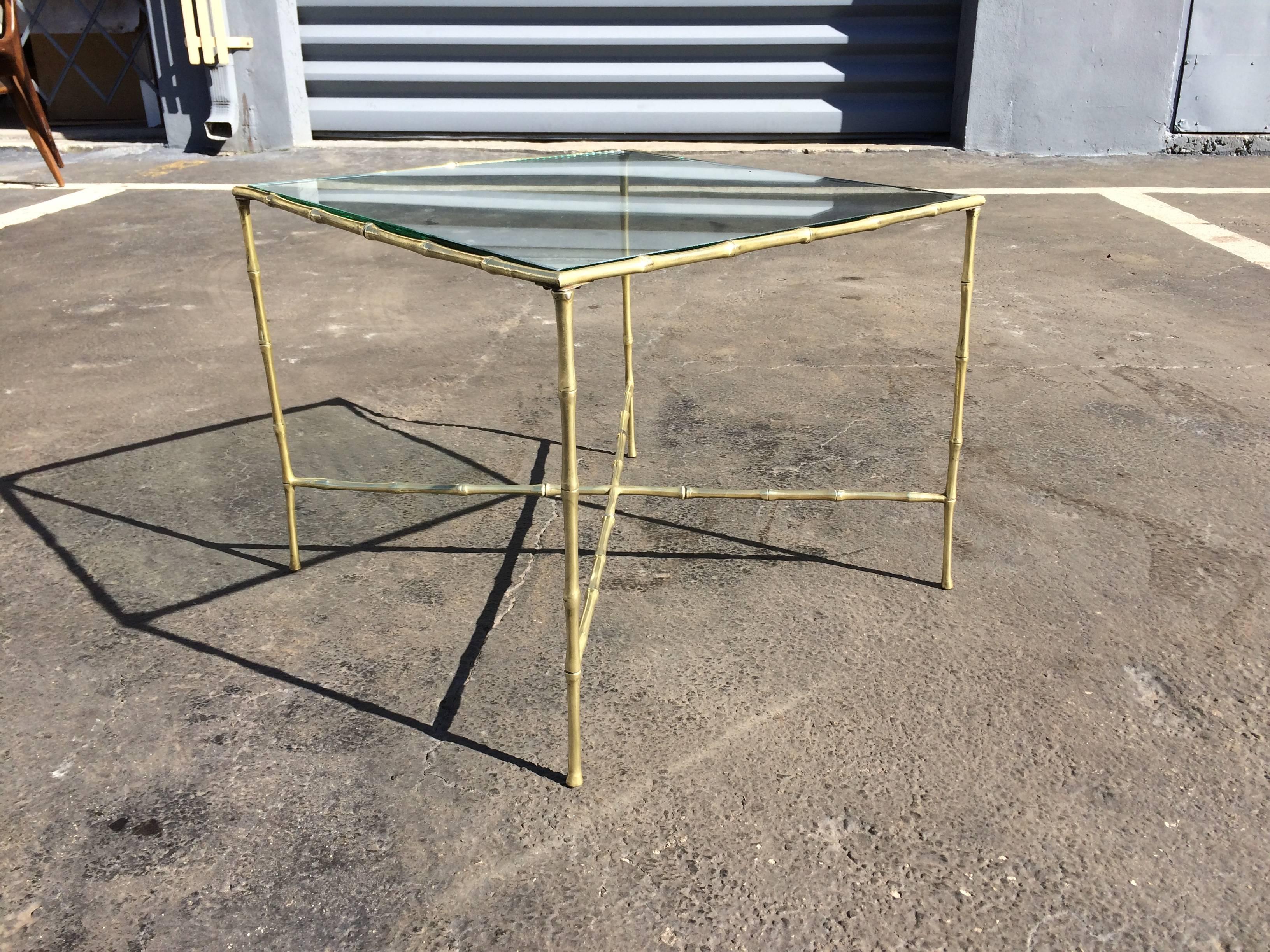 Faux bamboo brass side table with solid brass frame with glass top.