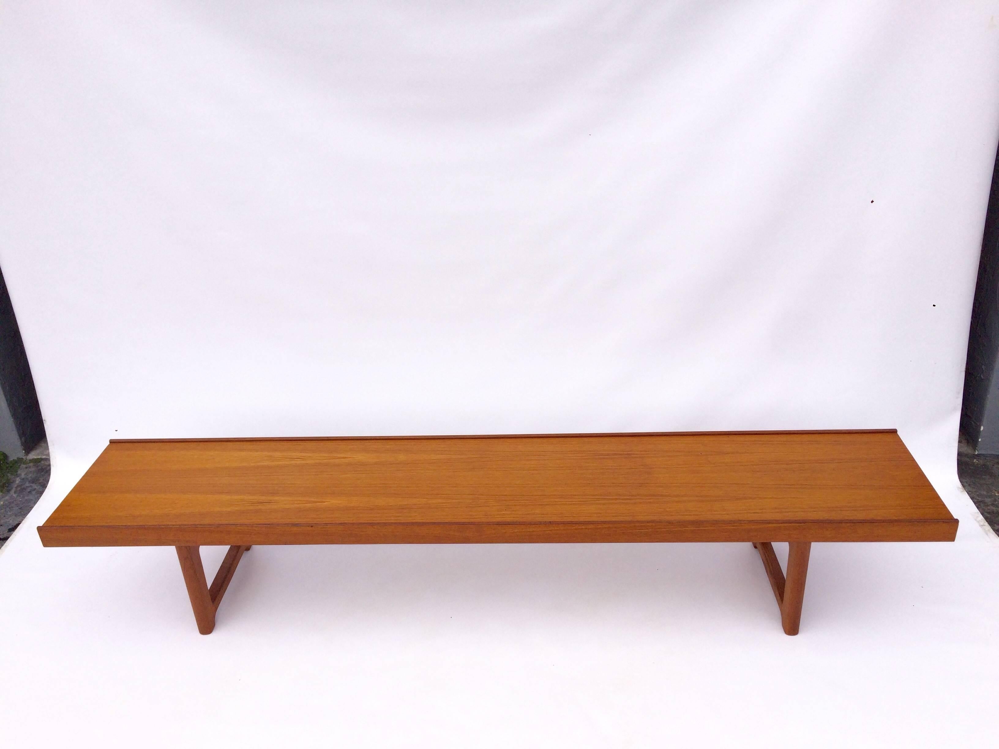 Teak bench with one removable planter. Planter is 23.50