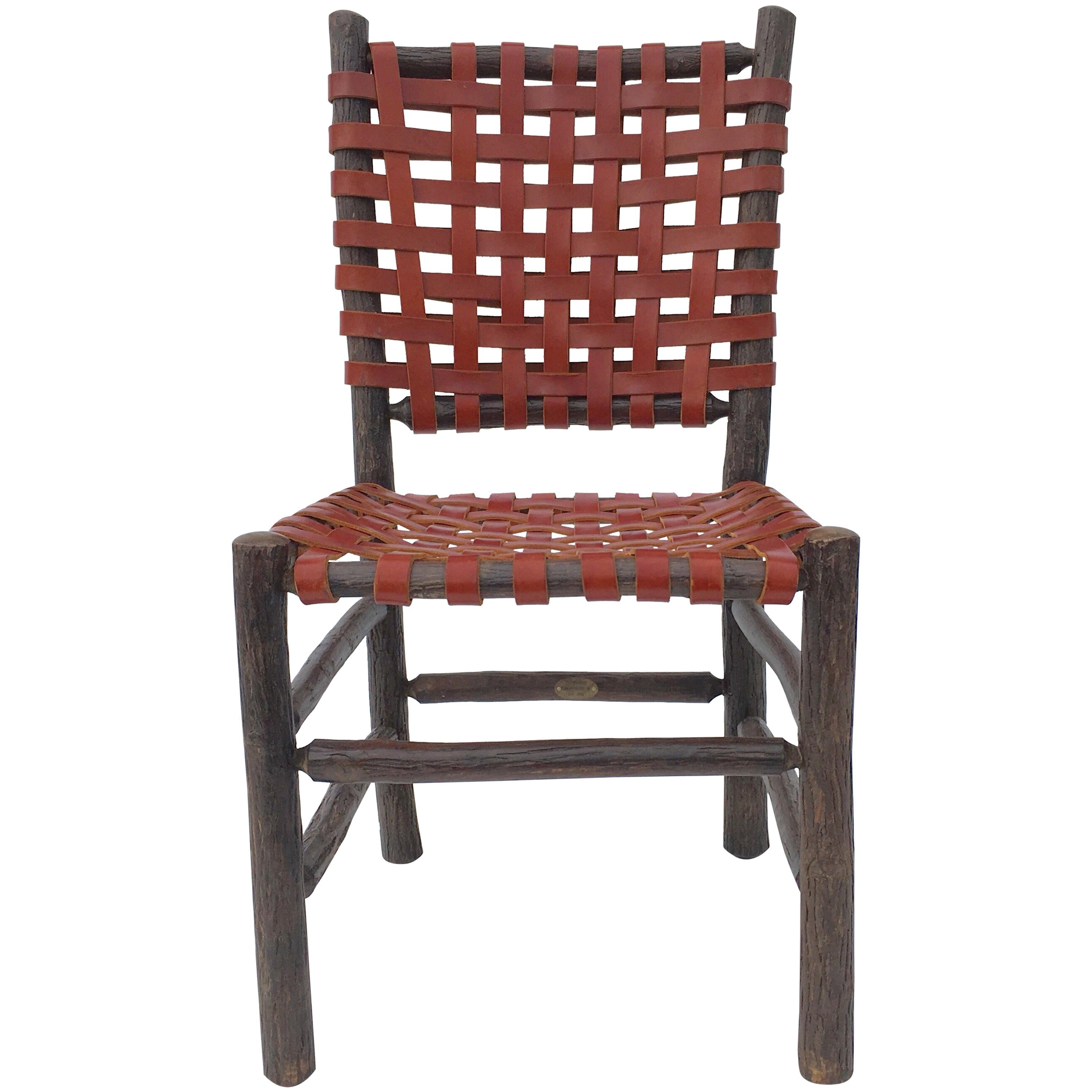 Ten signed old hickory chairs with woven saddle leather seats and backs. More chairs available.