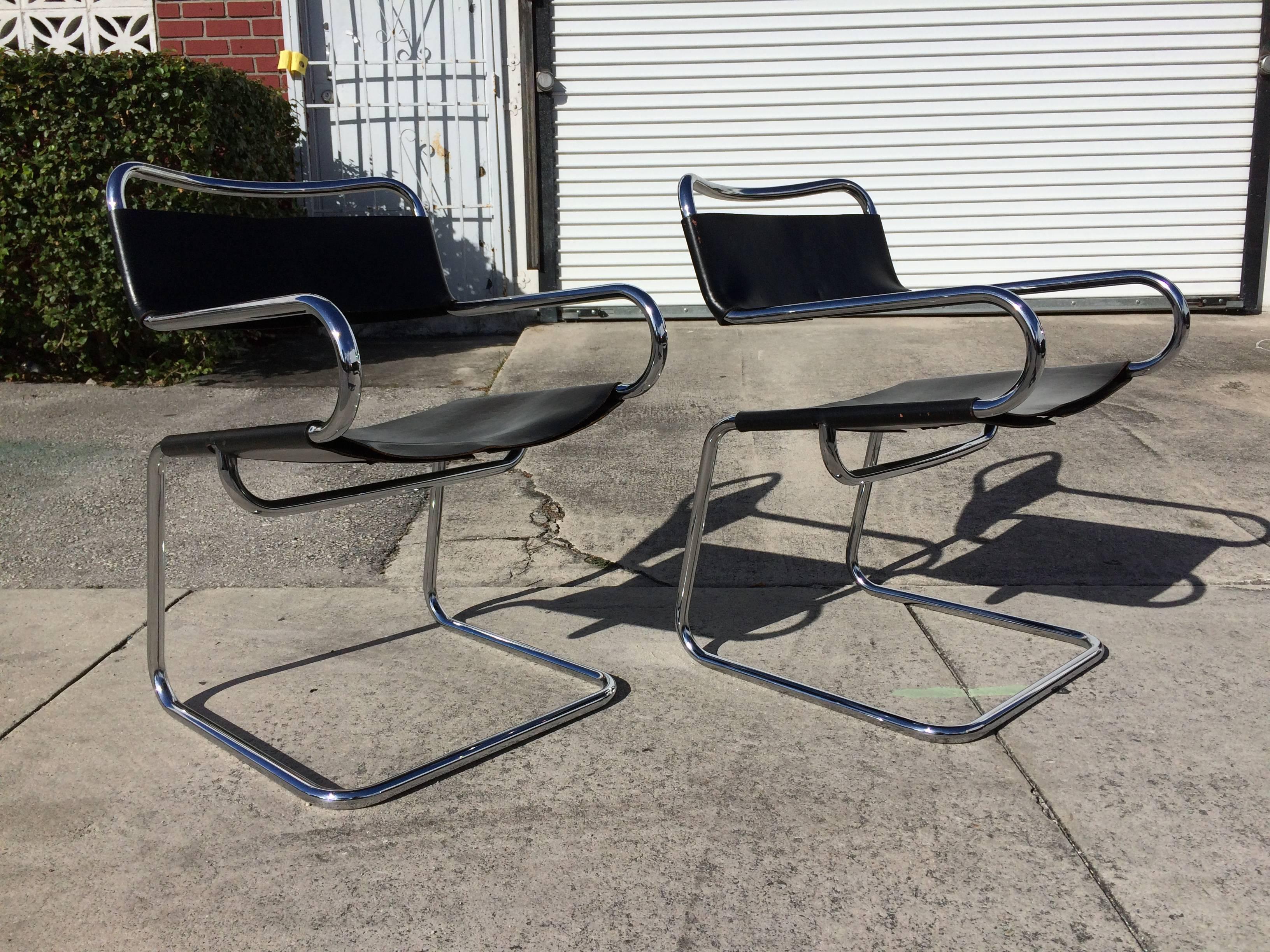 Pair of great Italian cantilever armchairs with saddle leather. Great form and quality.