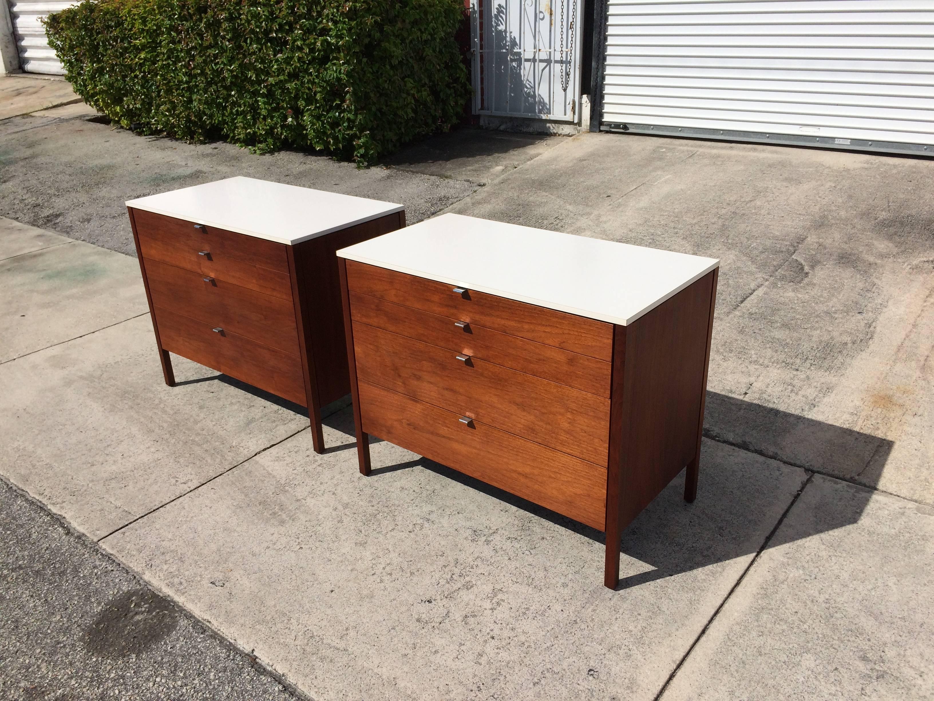 Walnut chests with white tops and backs, each chest has four drawers.
