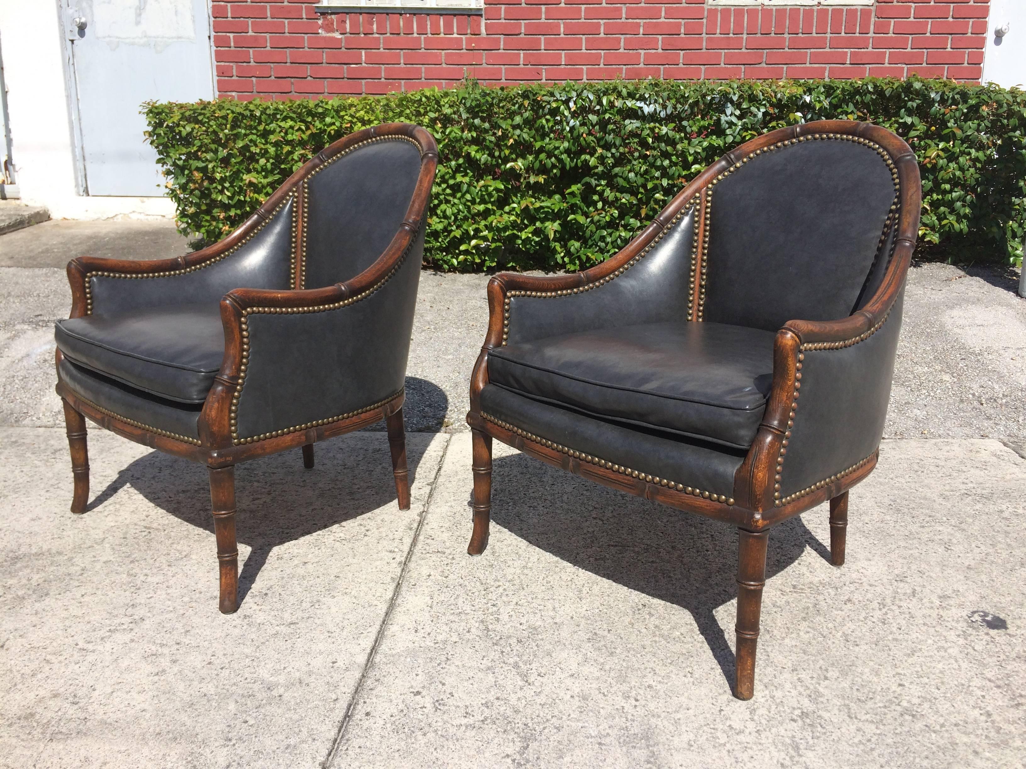 Solid wood frame with a faux bamboo design, brass nailheads and black faux leather upholstery, three chairs available.