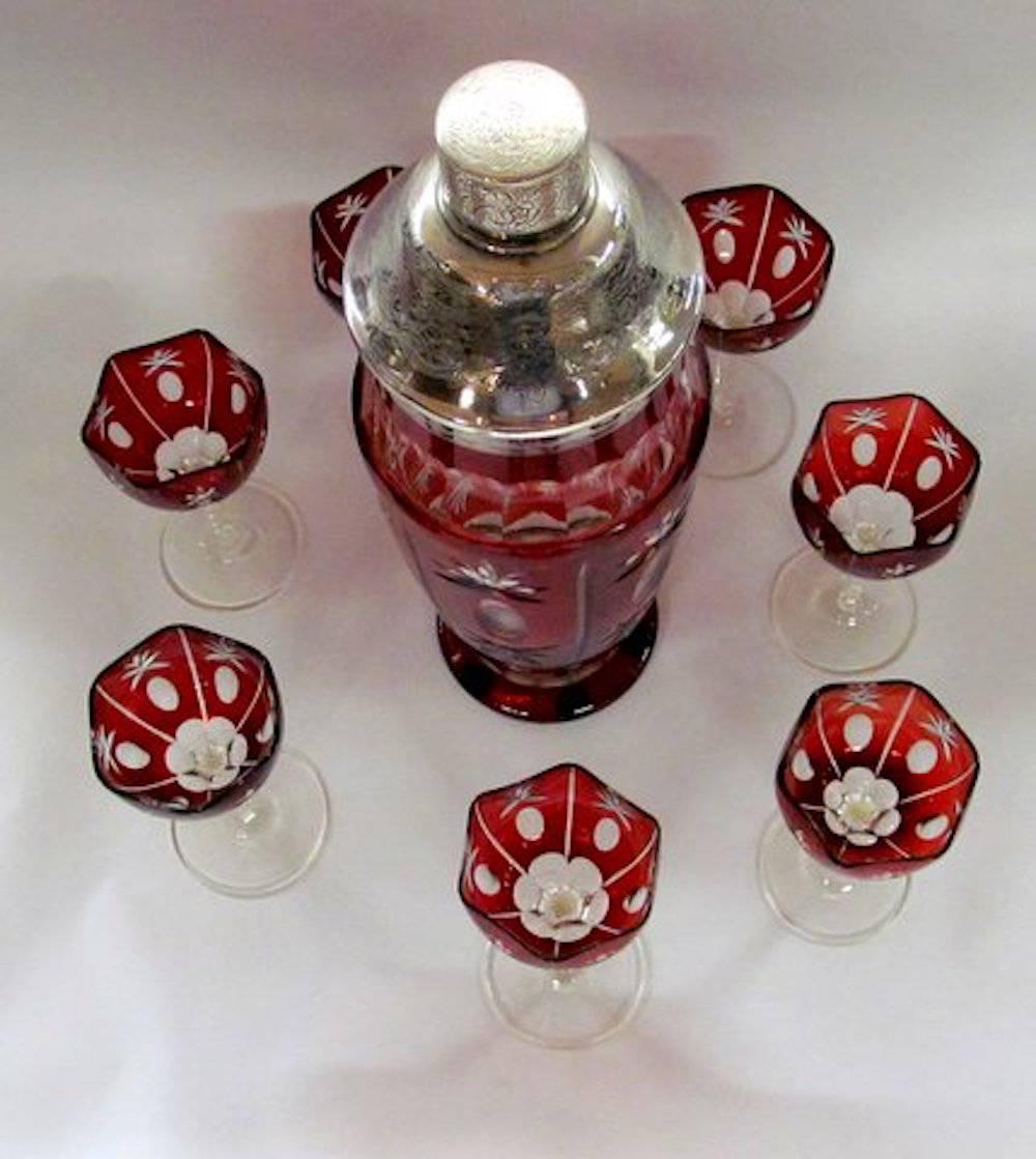 Exceptional and rare old Austrian hand-cut ruby overlay (cut-to-clear) crystal cocktail or martini set with hallmarked .800 fine silver lid and fittings.
Seven glasses, one shaker.

Please note fabulous hexagonal shape hand-cut overlay ruby