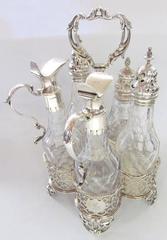 George III English Sterling Silver Five-Bottle Cut Crystal Warwick Cruet Set