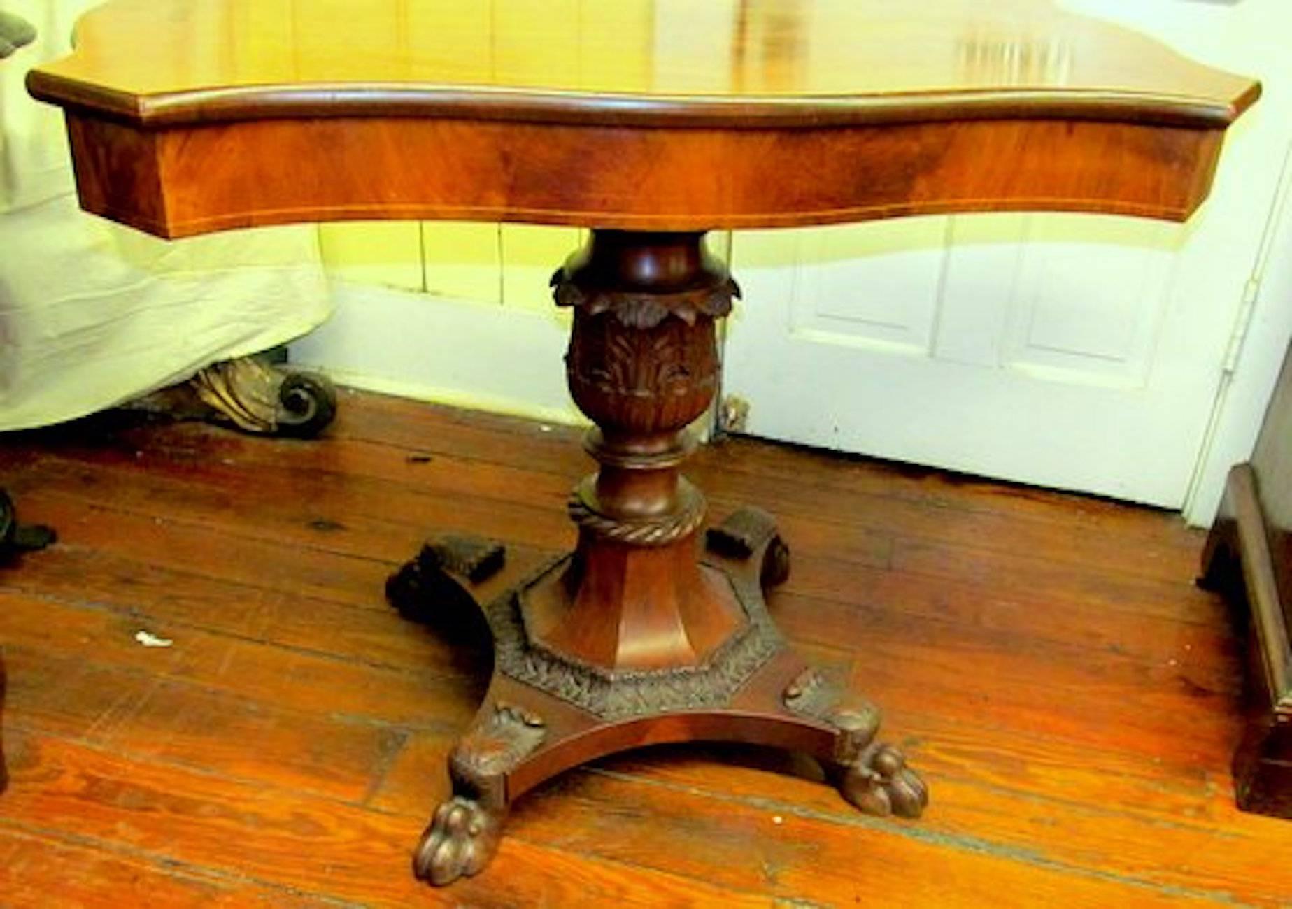 Antique American Empire flame mahogany console or center table with fabulous pineapple carved urn-shaped pedestal.
 
Please note exceptional hand-carved 