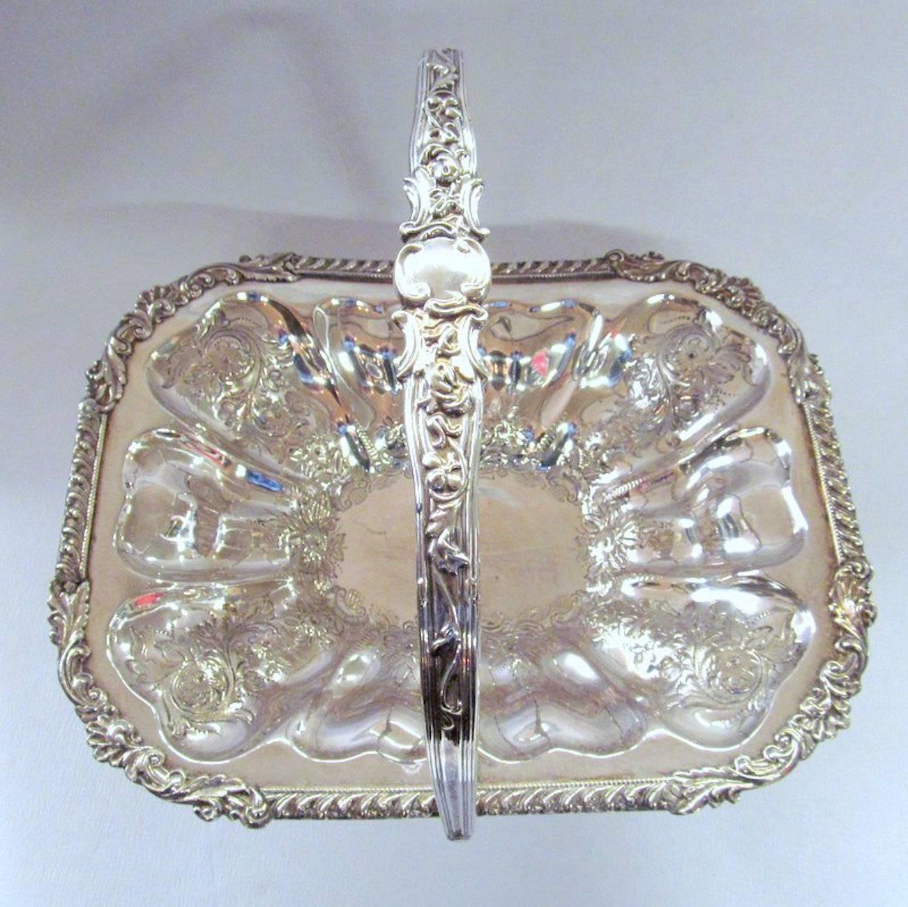 Fabulous hand chased cake, fruit, bread or flower basket, very heavy quality. Superb shell and gadroon mounted border. Pristine condition.

Maker's marks under base for John Sherwood & Sons (Birmingham), one of England's most highly prized silver