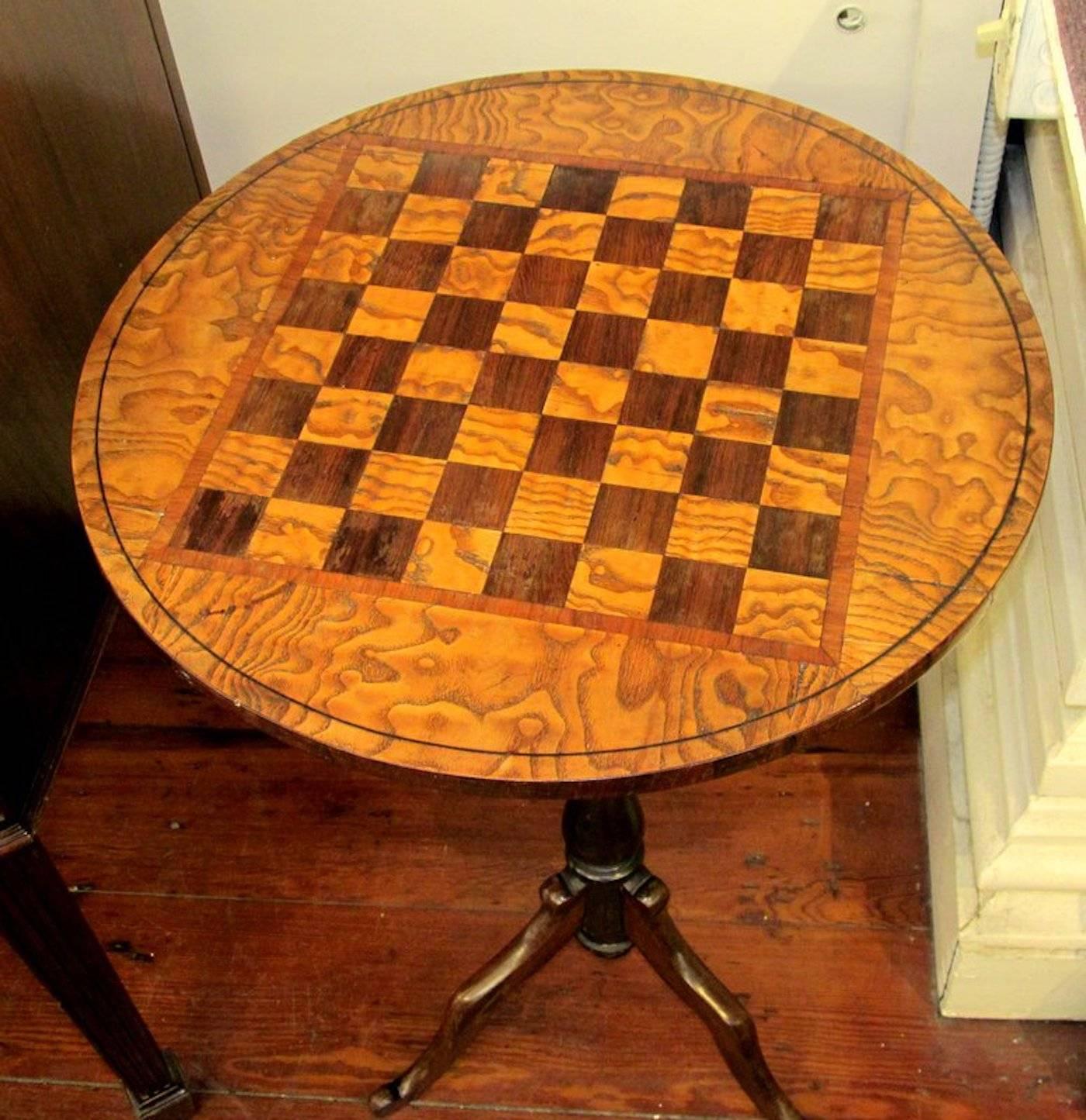 Rare antique English rosewood and elm round games table, beautifully inlaid with a chess/checkerboard top in alternating rosewood and burr elm squares,
circa 1865-1885.
