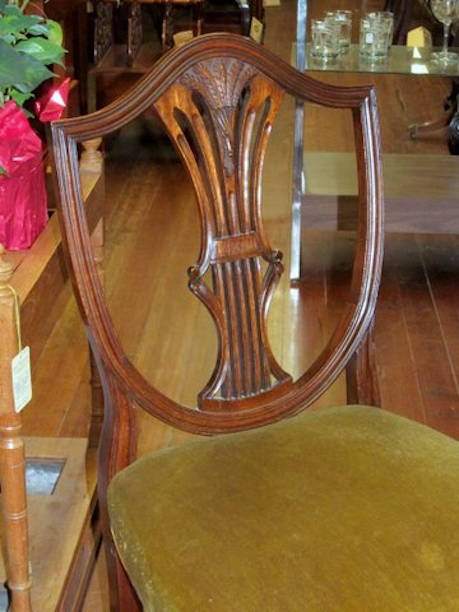 Set of eight old English solid mahogany hand-carved shield-back Hepplewhite style dining chairs with wheat sheaf in center splat.

Six side and two armchair.

 