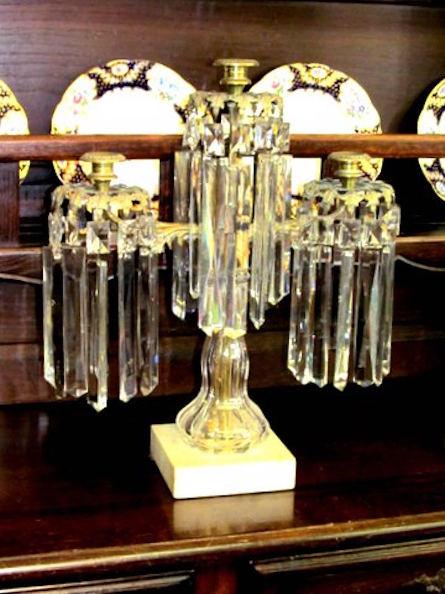 Fabulous quality suite of three antique French brass and panel cut crystal garniture set with period prisms. Very rare with crystal center sections. Some prisms missing and are a/f.        3 lt. Candelabrum 19 1/2